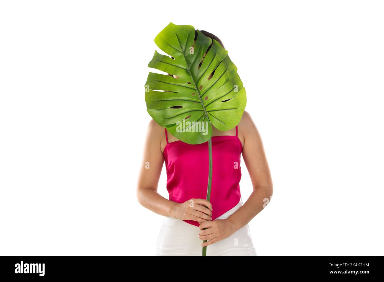 Schönheit Brünette Frau mit einem grünen Blatt isoliert auf einem weißen Hintergrund Stockfoto