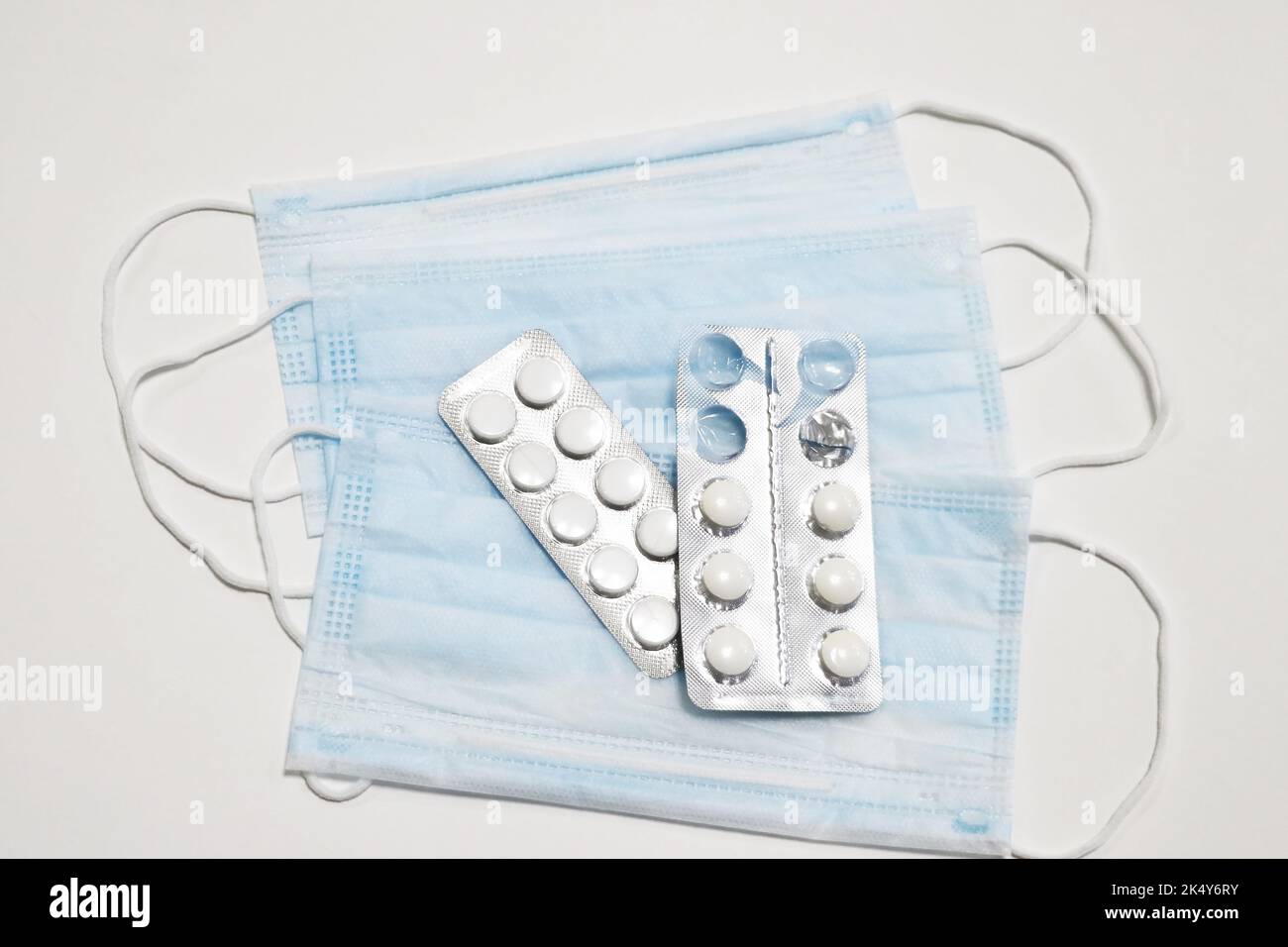 Eine Nahaufnahme einer chirurgischen Gesichtsmaske und Pillen Stockfoto