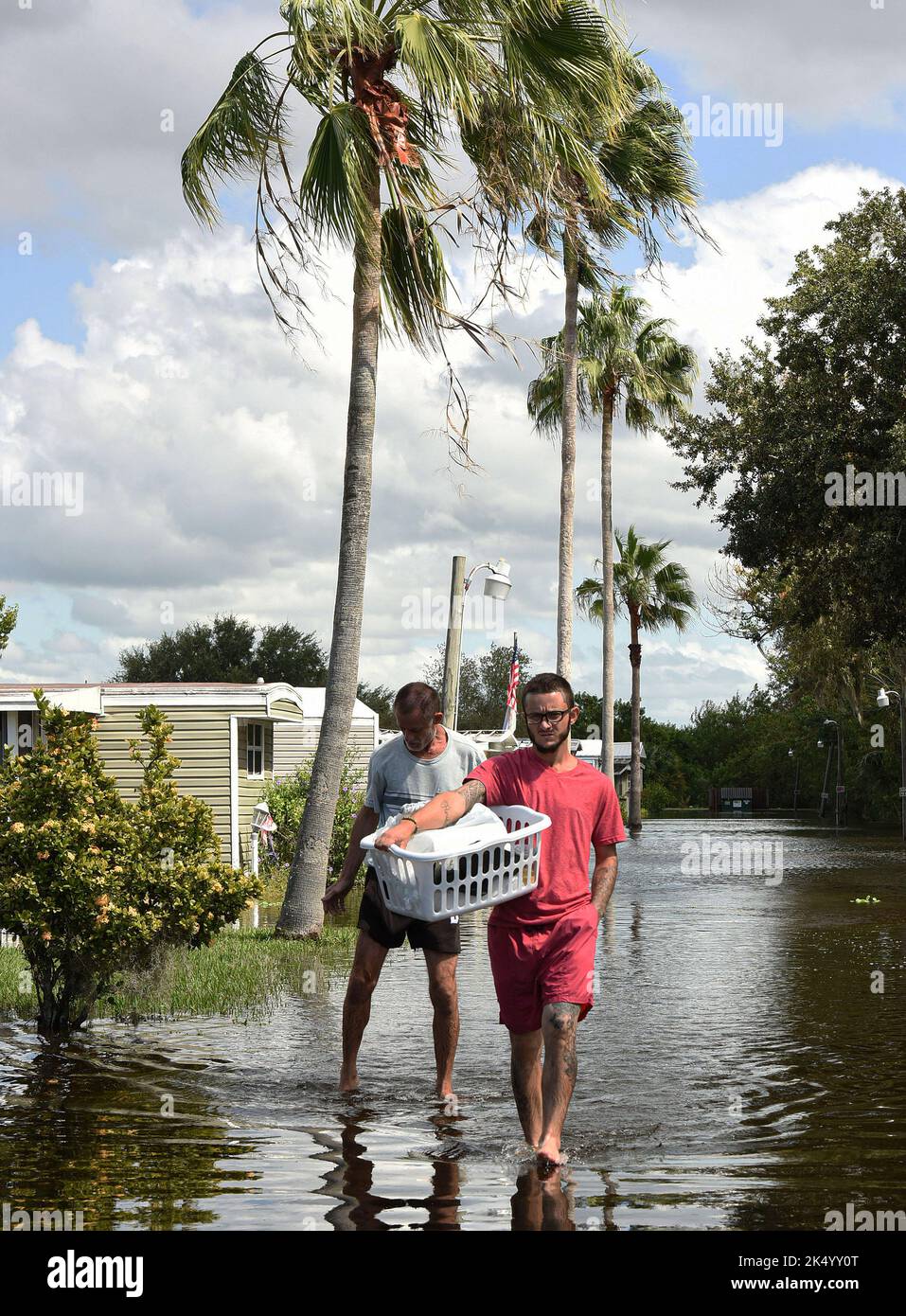 Ron Harris (L) und Anthony Bednarz (R) waten durch eine überflutete