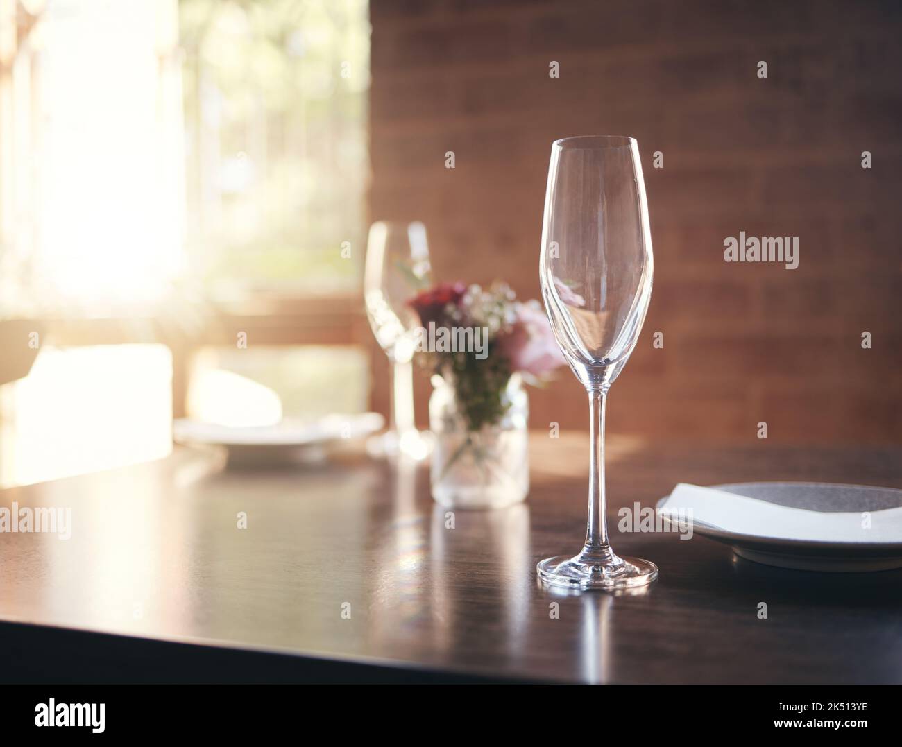 Leeres Glas auf dem Tisch für Wein, Champagner oder Alkohol beim Abendessen im romantischen Restaurant, zu Hause oder im Restaurant. Luxus, Mittag- oder Abendessen mit Kristallweinglas Stockfoto