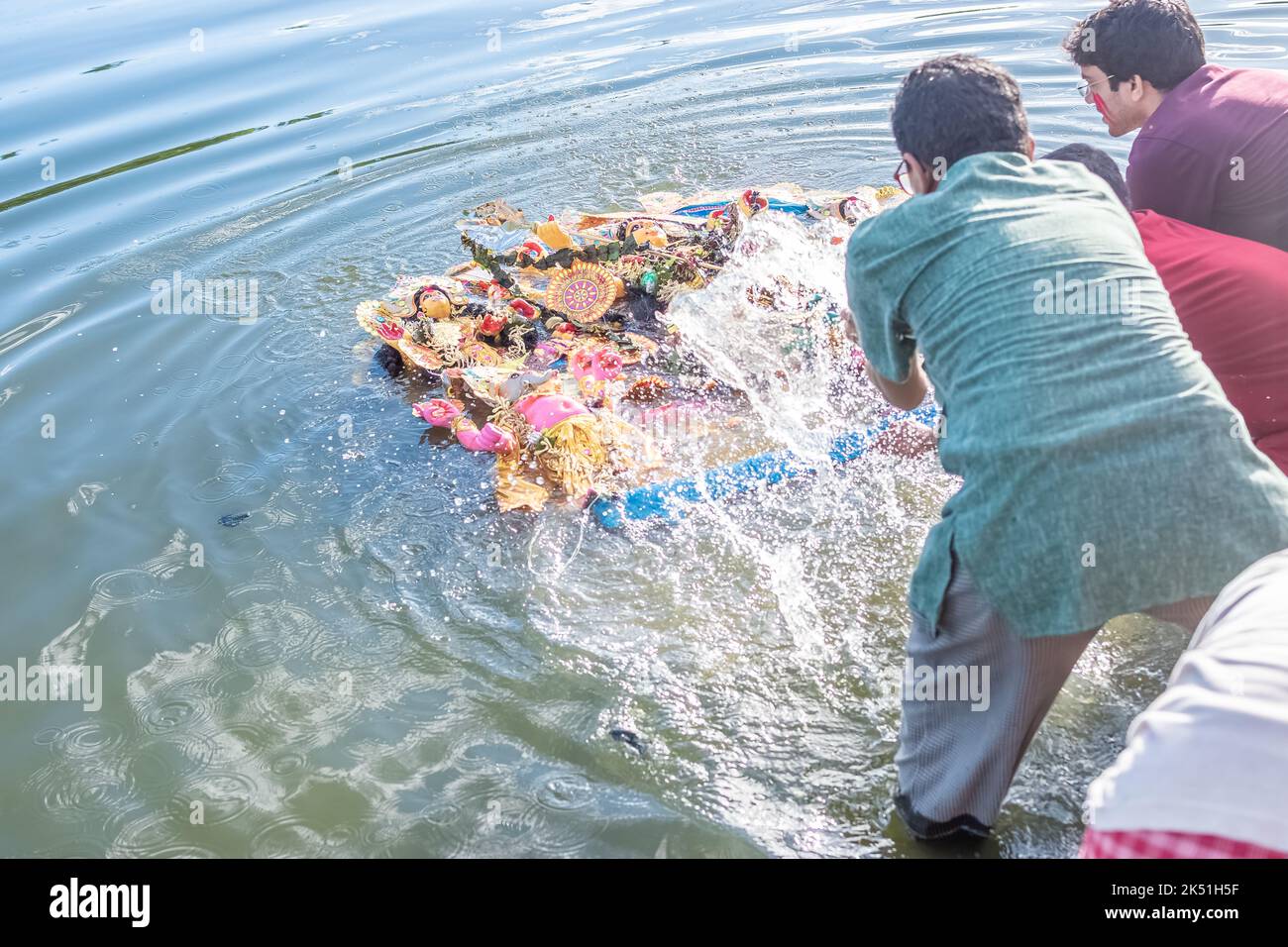 Anhänger tauchen Durga Idol auf dem Fluss Ganges während des letzten Tages des Durga Puja Festivals ein. Stockfoto