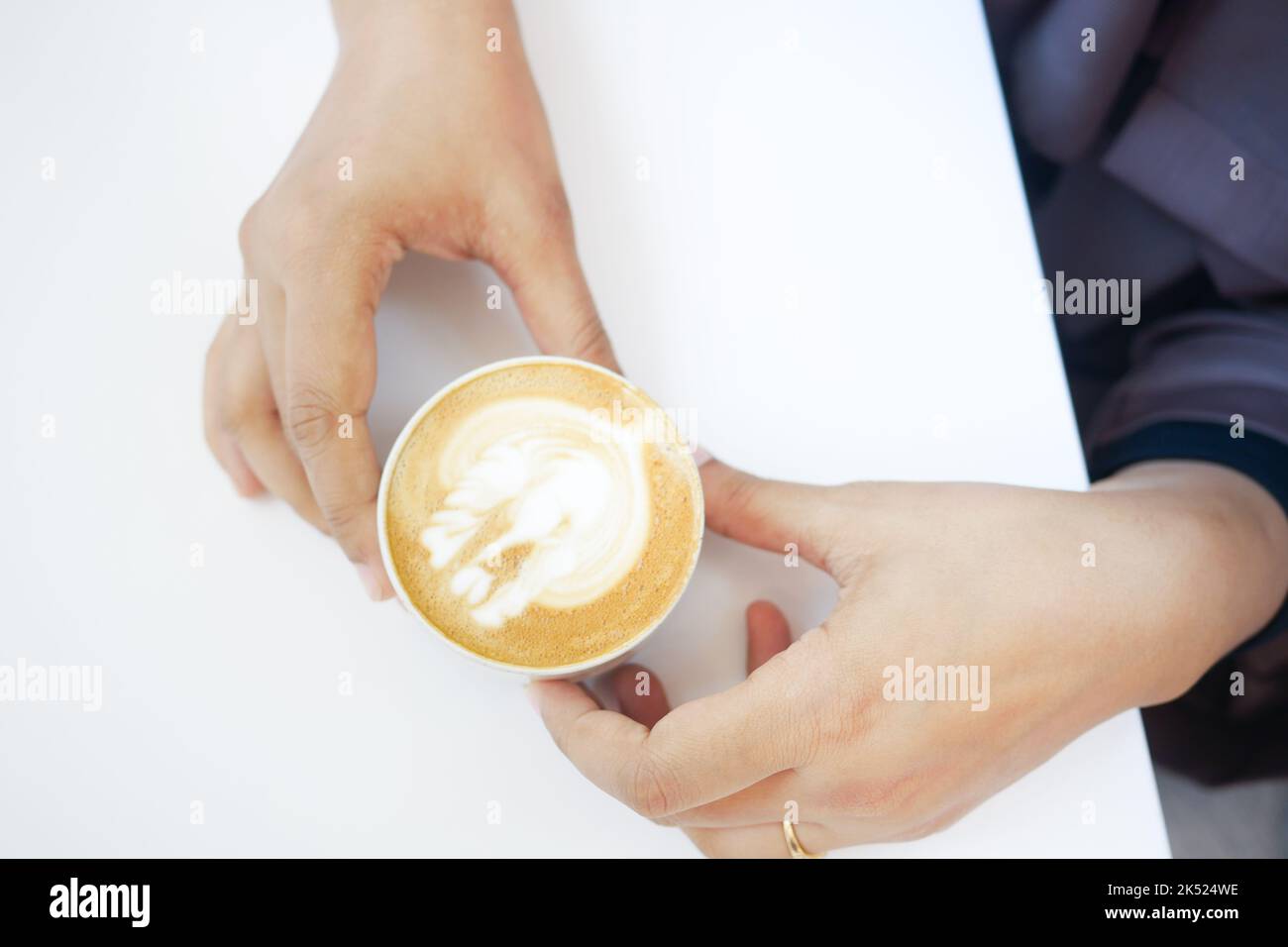 Draufsicht auf eine Tasse späten Kaffee mit herzförmiges Design auf dem Kaffeetisch Stockfoto