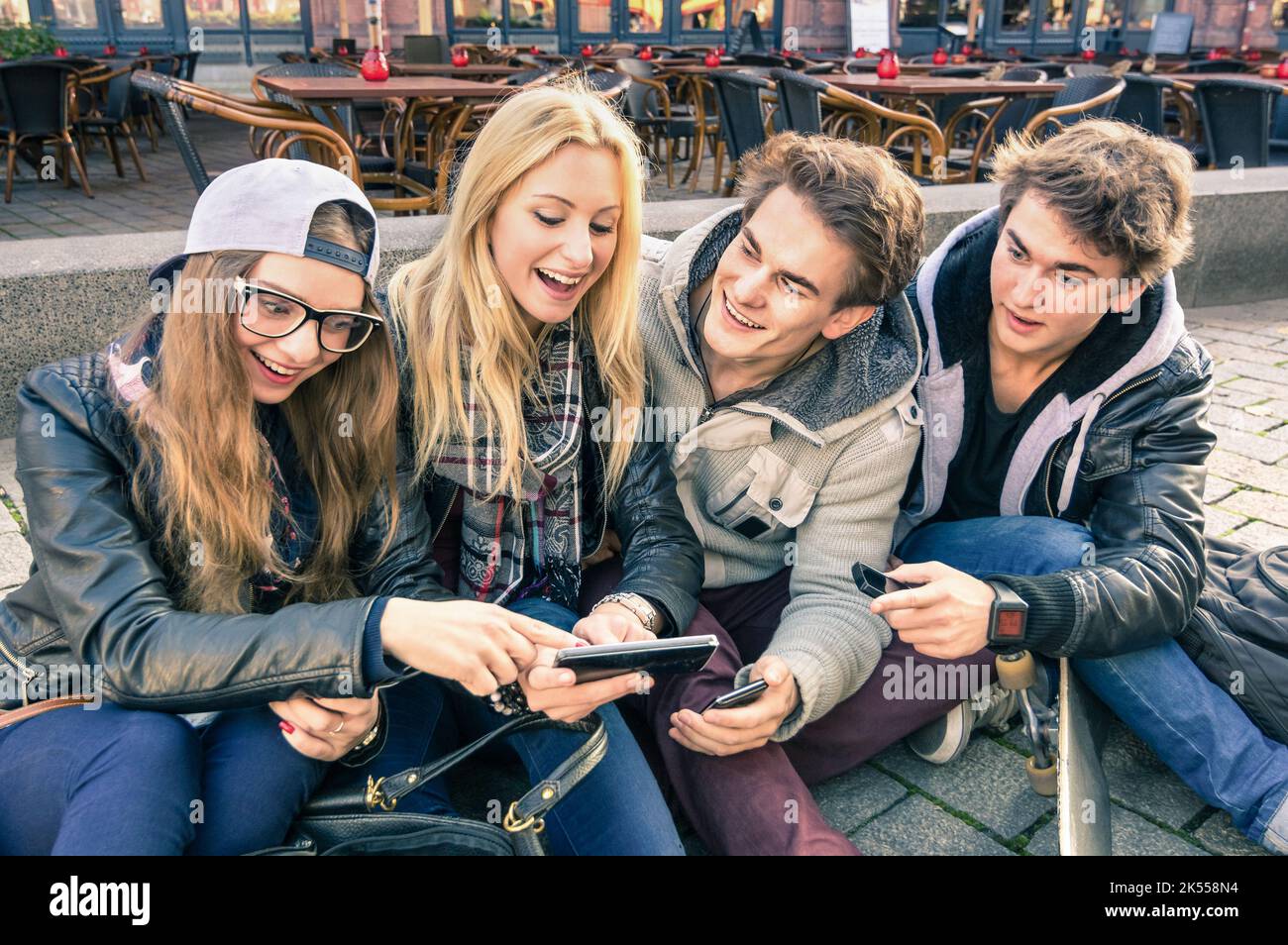 Gruppe junger Hipster-Freunde, die Spaß zusammen mit dem Smartphone haben - moderne Situation der Technologie-Interaktion im Alltag - Internet WiFi Stockfoto