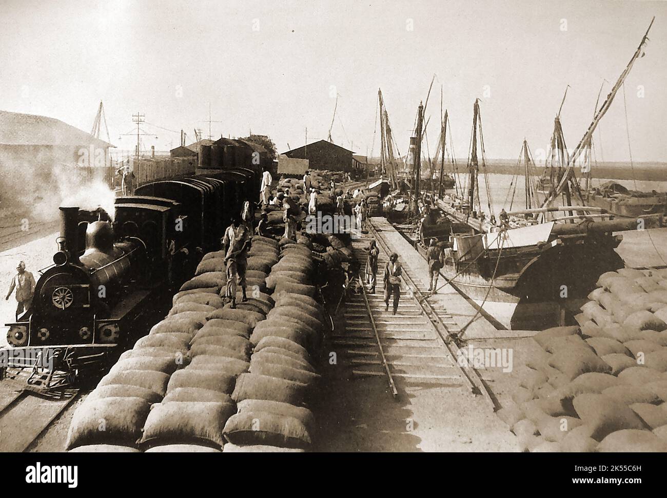 Ein Blick nach dem Krieg in den 40er Jahren auf den Hafen von Porbandar, Indien, wo Säcke mit Erdnüssen (Erdnüssen) für den Export geladen werden. Porbandar ist eine Stadt im Bundesstaat Gujarat, bekannt als Geburtsort von Mahatma Gandhi und Sudama (Kuchela), einem Freund der Hindu-Gottheit Krishna. Indien ist immer noch einer der weltweit führenden Erdnusszüchter. ---- جنگ 1940 کے بعد پوربندر بندرگاہ، بھارت کا ایک منظر جہاں مونگ پھلی کی بوریاں برآمد کے لیے بھری جا رہی ہیں --- युद्ध के बाद 1940 के दशक में पोरबंदर बंदरगाह, भारत का दृश्य जहां निर्यात के लिए मूंगफली की बोरियां लादी जा रही हैं Stockfoto