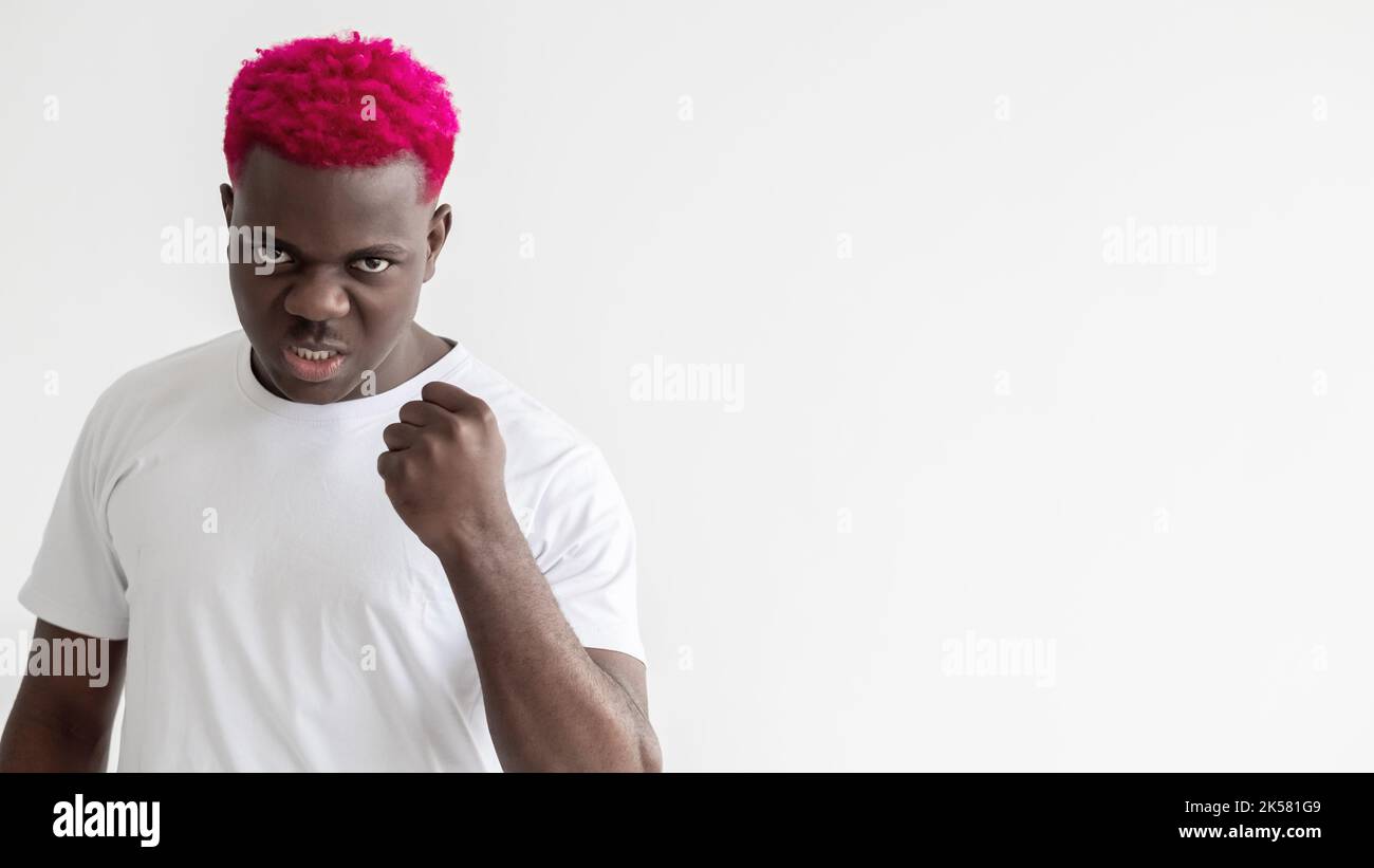 Brutaler Mann. Schwarze Leben sind wichtig. Geste bedrohen. Widerstrebige Gegner. Sozialer Druck. Hintergrund der Werbung. Aggressiver afrikanischer Kerl mit rosa Haaren Stockfoto