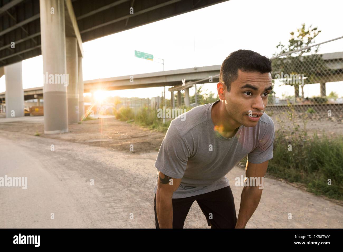 Mittelerwachsener Mann erholt sich von einem Lauf in der Stadt Stockfoto