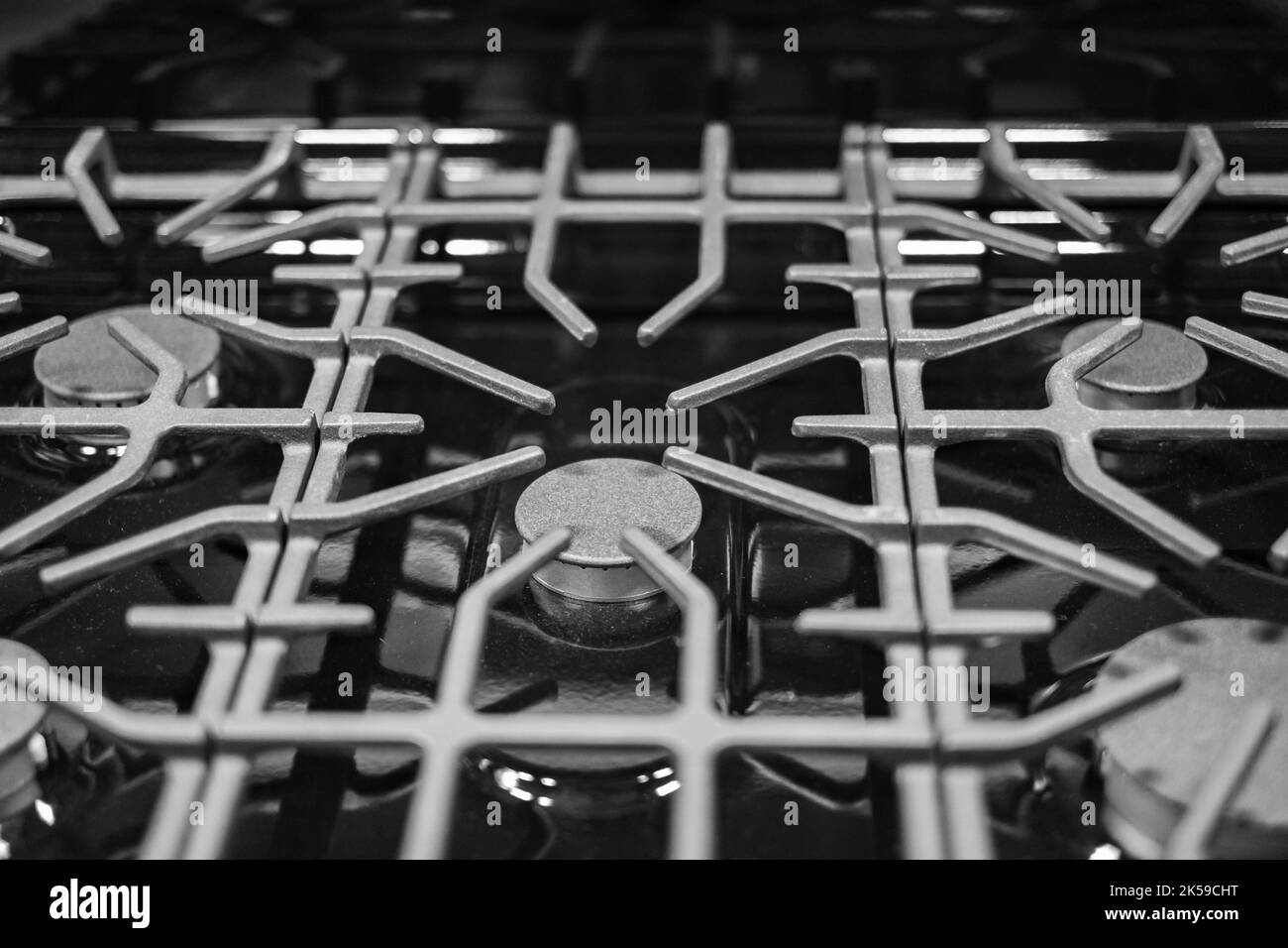 Küchenoberfläche aus Edelstahl mit gusseisernem Grill. Blick von oben. Herd Kochen Küche Herd Metall-Brenner Gas Küche Elektro-Heißkochfeld Stockfoto