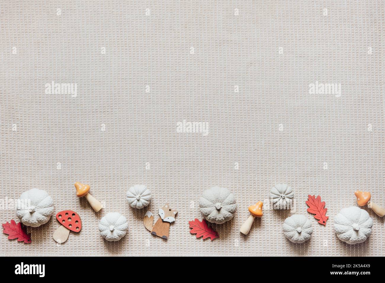 Herbst kreative Handwerk Hintergrund mit dekorativen Ton Kürbisse und Holz Herbstblätter. Dekorative Kürbisse flach legen auf Naturstoff-Hintergrund Stockfoto