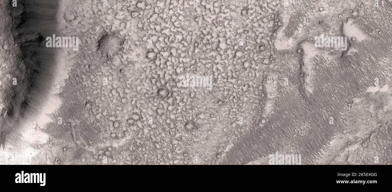 Marsatlandschaft. Diese HiRISE-Aufnahme zeigt die gesteinerte Oberfläche im Tartarus Montes, Mars.Ziel dieser Beobachtung ist es, die Beschaffenheit einer stark gesteinerten Oberfläche zu bestimmen. Die Wand einer Grube wird mit einer benachbarten Grube geteilt. Die Hitze der Lava kann dazu geführt haben, dass sich das Bodeneis zu Dampf verwandelte und die Gruben formte. Eine einzigartige optimierte Version von NASA-Bildern. Quelle: NASA/JPL/UArizona Stockfoto