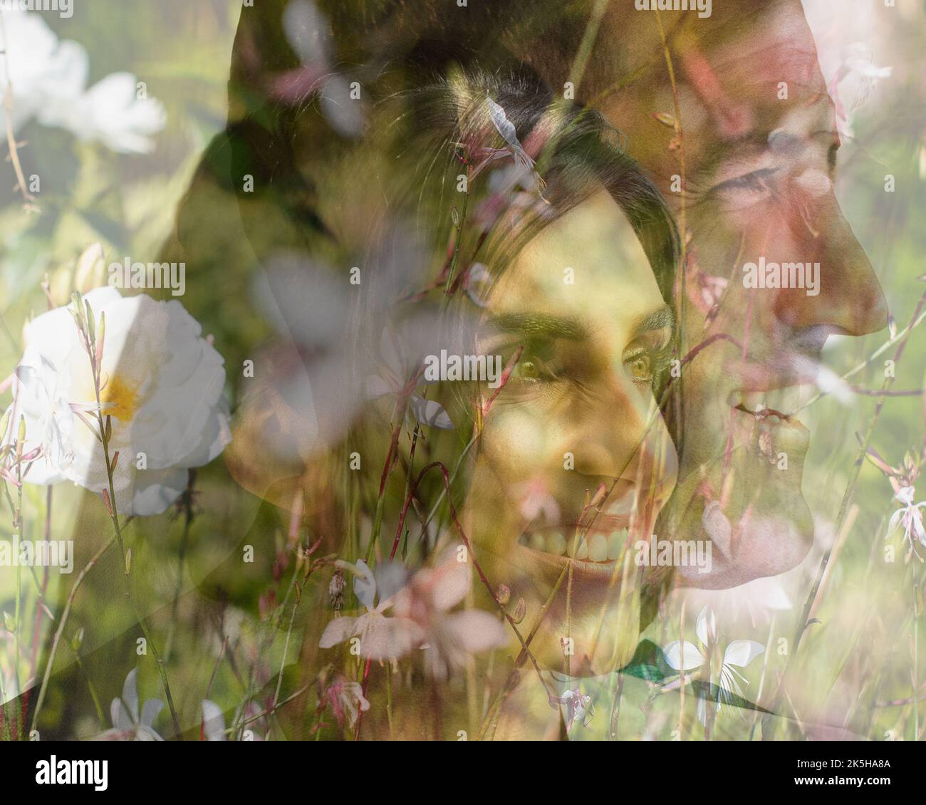 Verheiratet Älteres Paar, das in die Zukunft blickt, Sonnenlicht, das ihre Gesichter umrahmt von Blumen beschnitten, doppelt belichtet, lächelndes Paar, das aus dem Rahmen blickt. Stockfoto