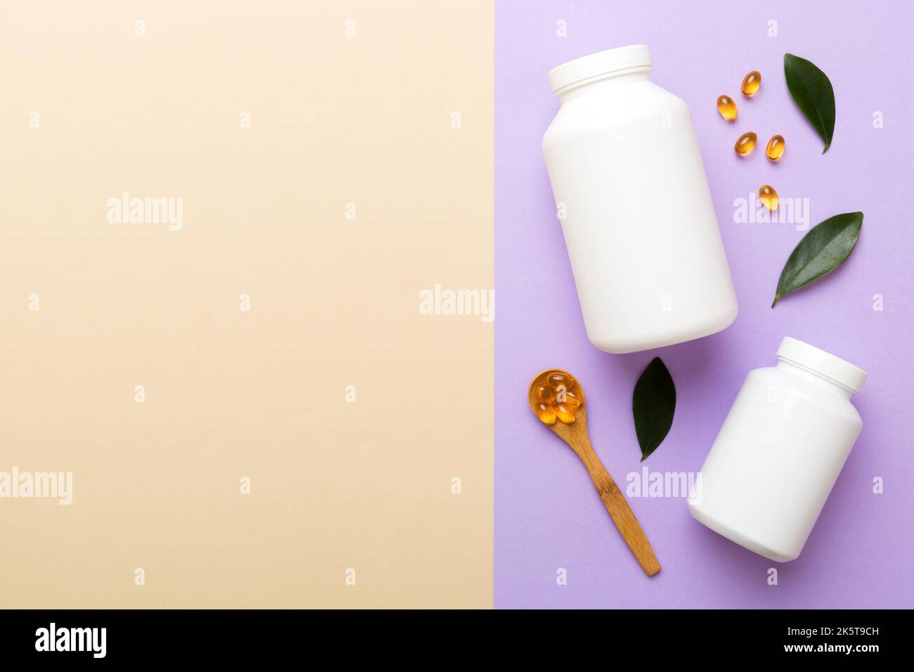 Omega-3 Kapseln liegen in einer weißen Flasche auf einem Tisch mit grünem Blatthintergrund. Fischöltabletten. Biologisch aktive Zusatzstoffe. omega 6, Omega 9, Vitam Stockfoto