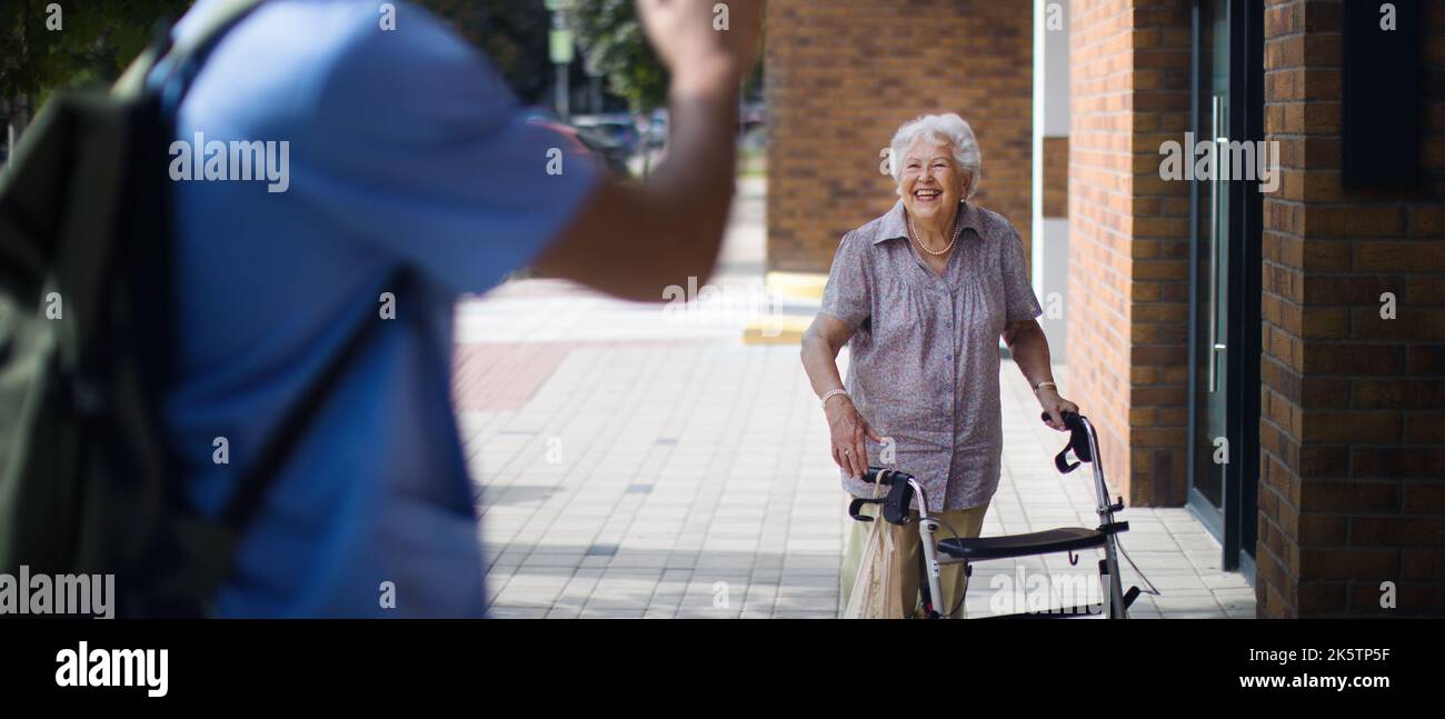 Pfleger sagt, Auf Wiedersehen sei seine ältere Klientin im Pflegeheim. Stockfoto