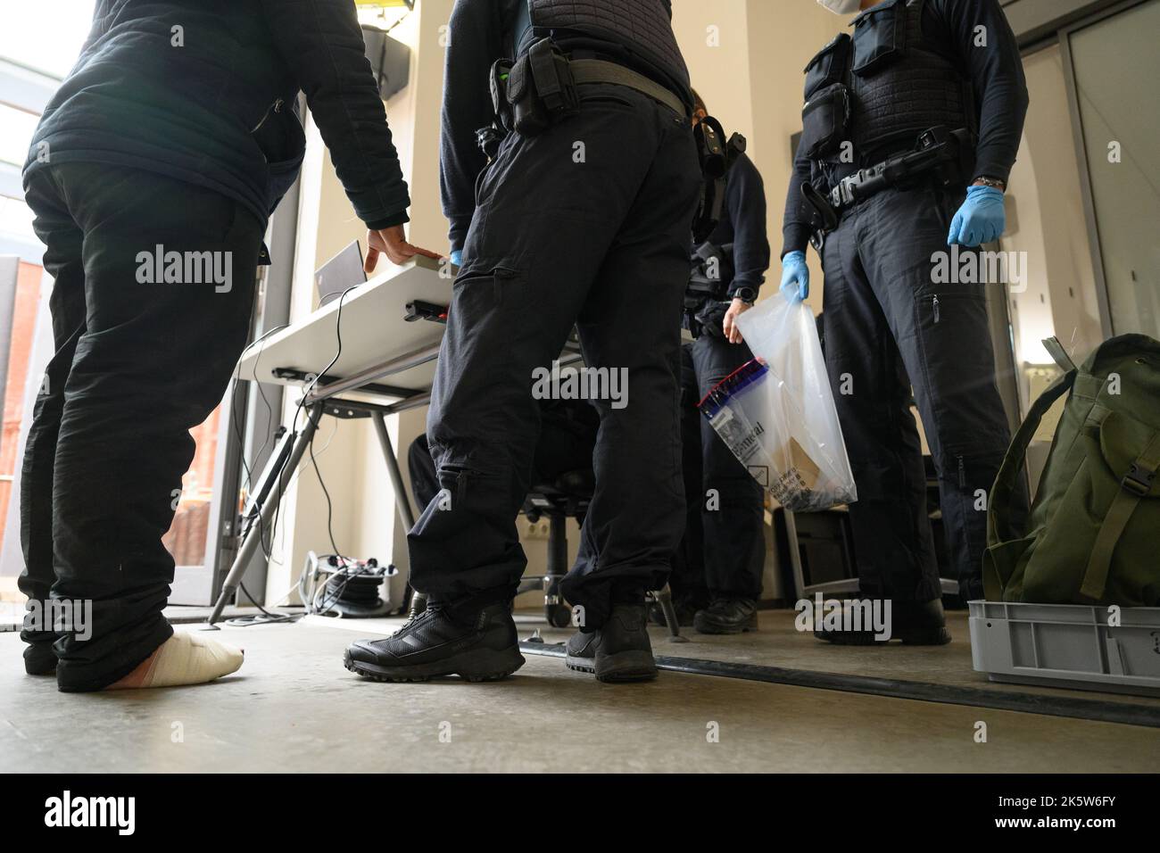 Dresden, Deutschland. 10. Oktober 2022. Ein Flüchtling aus Syrien, der an seinen Füßen gebunden ist, wird bei der Registrierung am PIK-Bahnhof (Personalisierungs-Infrastrukturkomponenten) im Ankunftsbereich für Flüchtlinge am Hauptbahnhof mit Fingerabdrücken abgedruckt. Kredit: Robert Michael/dpa/Alamy Live Nachrichten Stockfoto