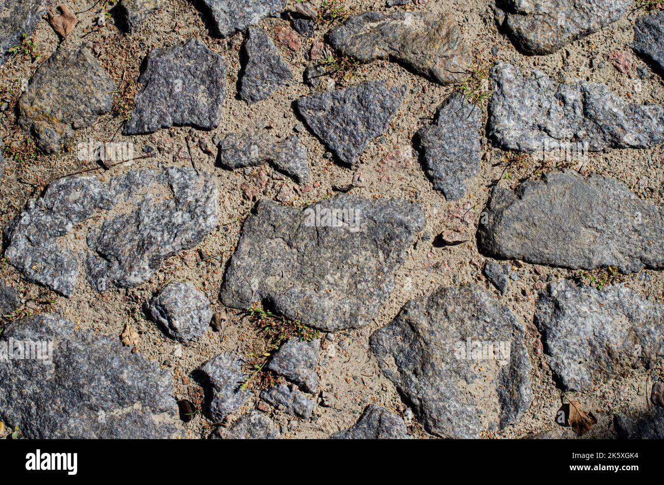 Block Stein Boden Textur Hintergrund Stein Block Straße Bürgersteig. Detail der Kopfsteinpflaster Pfad, Grunge Granit Wand Textur Stockfoto