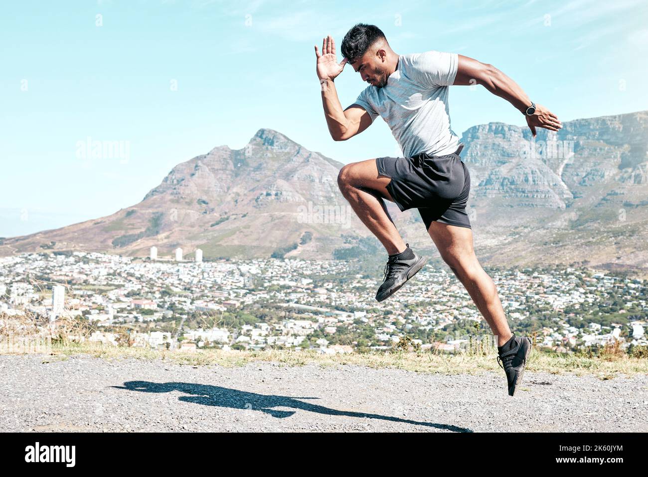 Sportlicher junger Mann mit gemischtem Rennen, der in der Natur im Freien sprintet. Passen Sie gut aussehenden hispanischen männlichen Athleten Mann für einen Lauf. Fitness Cardio und Ausdauer Stockfoto