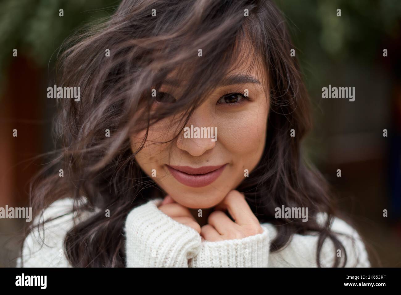 Schöne asiatische kasachische Brünette Frau mit fliegenden langen Haaren Stockfoto