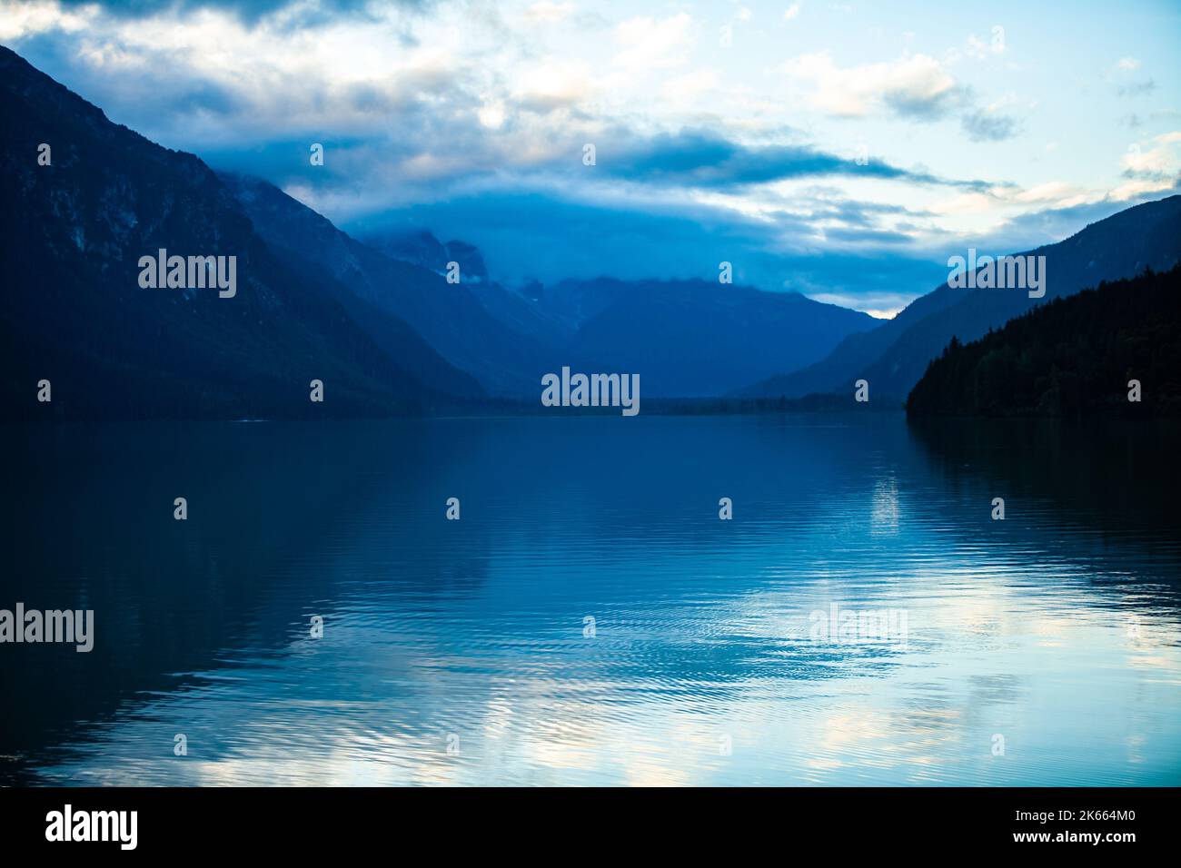 Eine malerische Aussicht auf den Chilkoot Lake mit nebligen Küstenbergen unter dem bewölkten Himmel Stockfoto