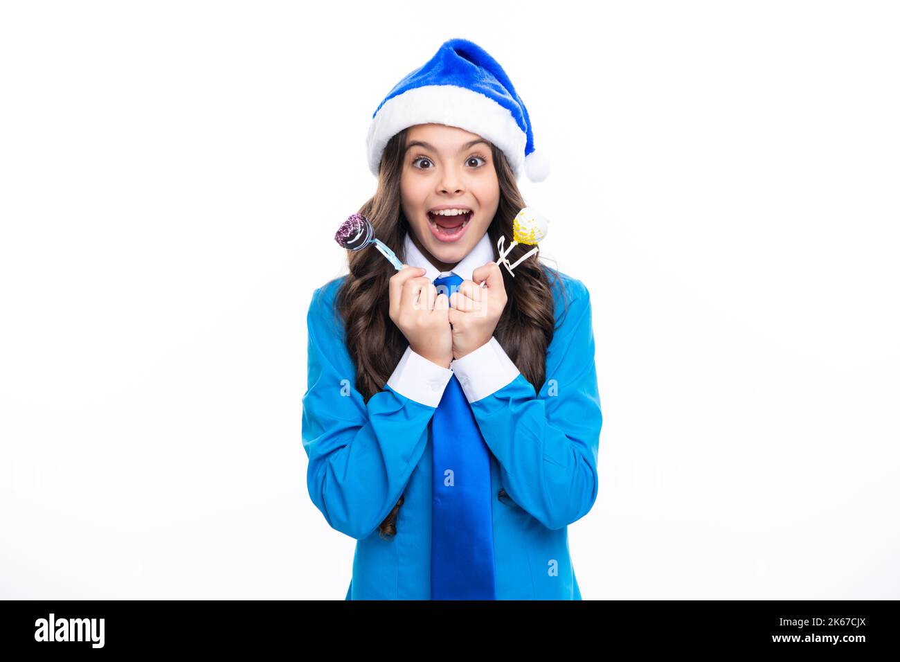 Portrait ein lächelndes Teenager-Mädchen mit blauem weihnachtsmann-Hut, Hemd und Krawatte halten weihnachtsbonbons Lollipop isoliert auf weißem Hintergrund. Frohe Weihnachten Stockfoto
