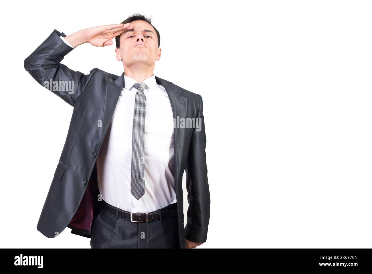 Soldat in formeller Kleidung grüßend im Lichtstudio Stockfoto