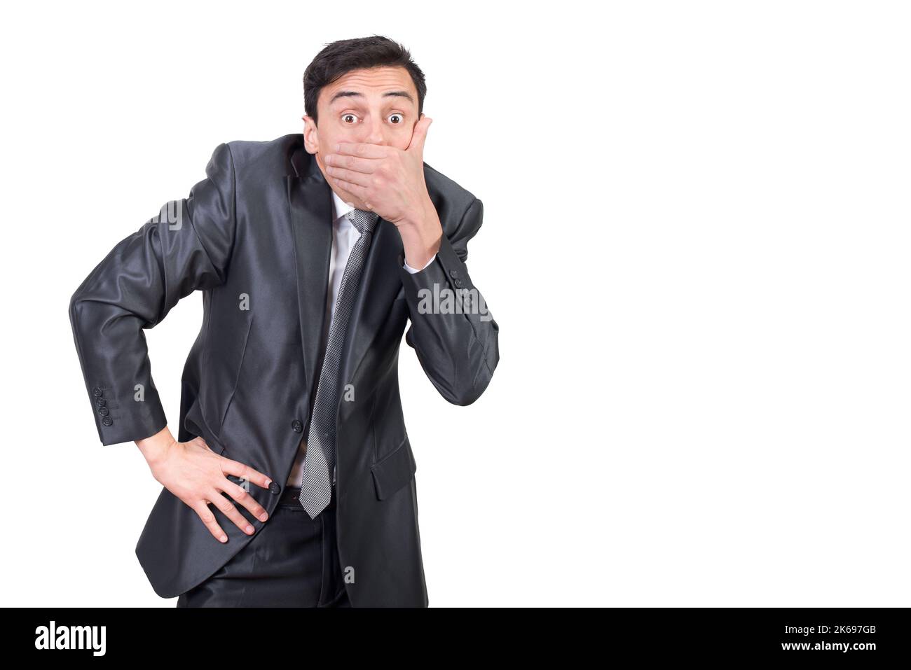Gesprächiger Mann im Anzug, der den Mund mit der Hand bedeckt Stockfoto