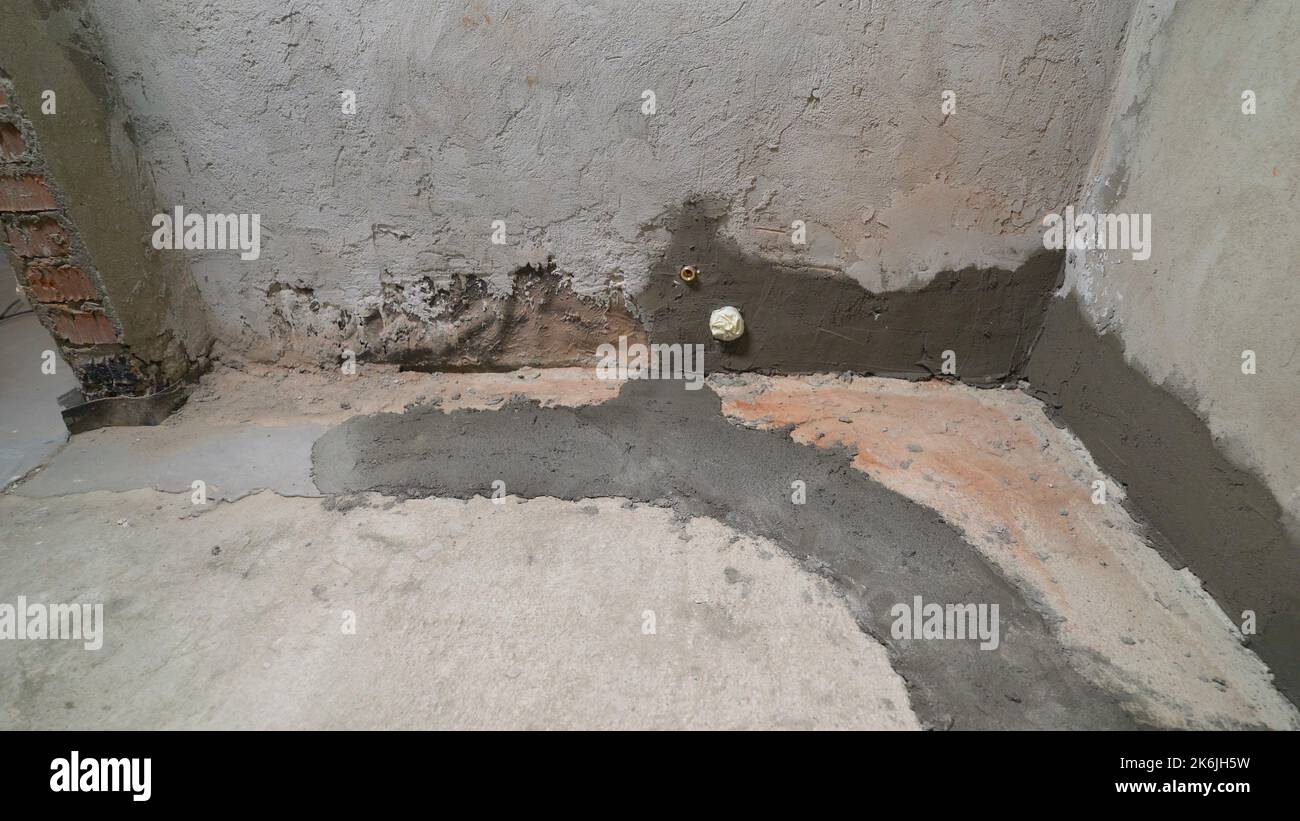 Renovierung des Badezimmerbodens. Das Bad wird renoviert und renoviert. Betonböden im Buggebäude. Betonboden in einer neuen Wohnung, Badezimmer. Stockfoto