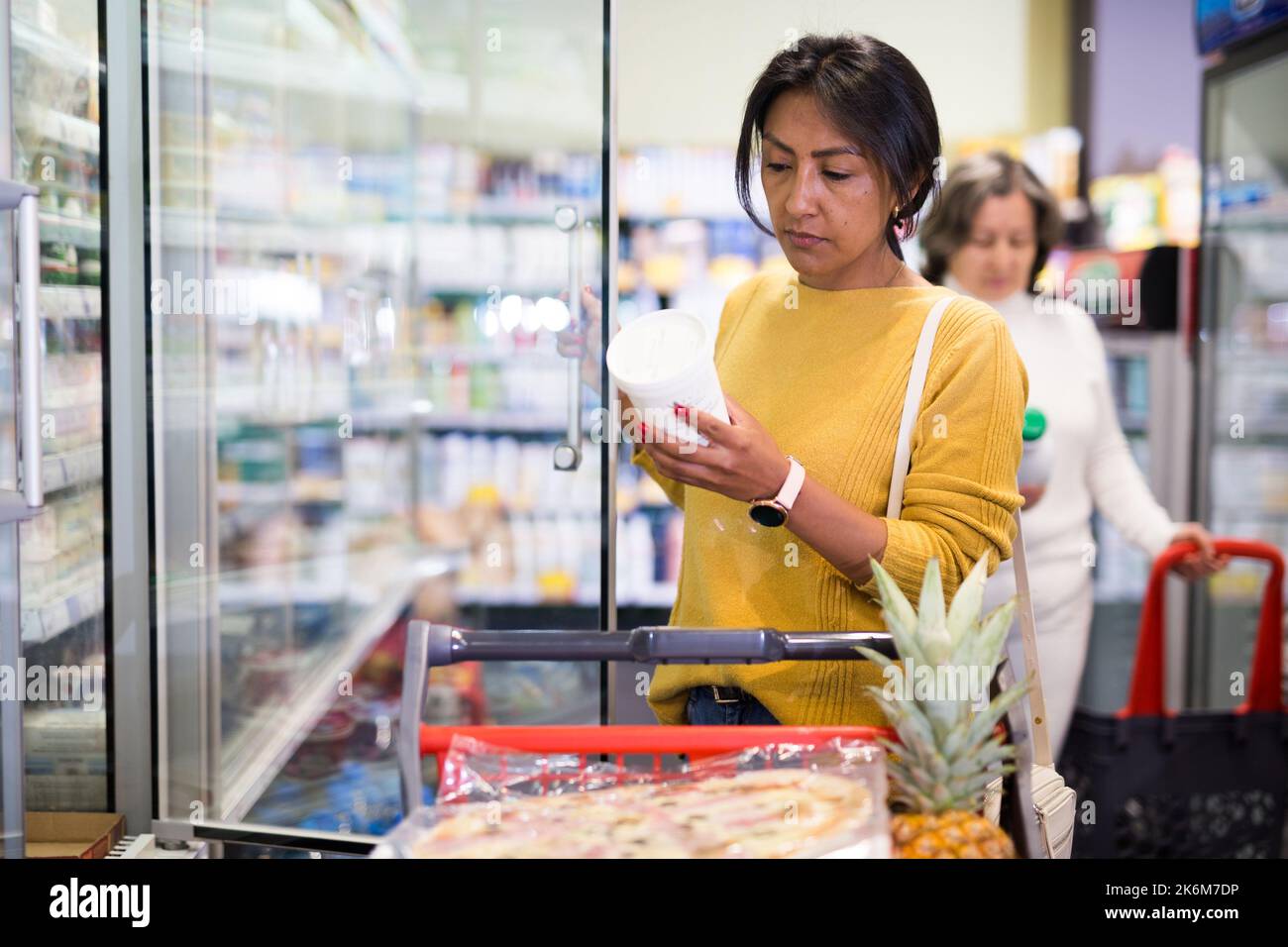 Weibliche Shopper wählt Milchprodukte im Supermarkt Stockfoto