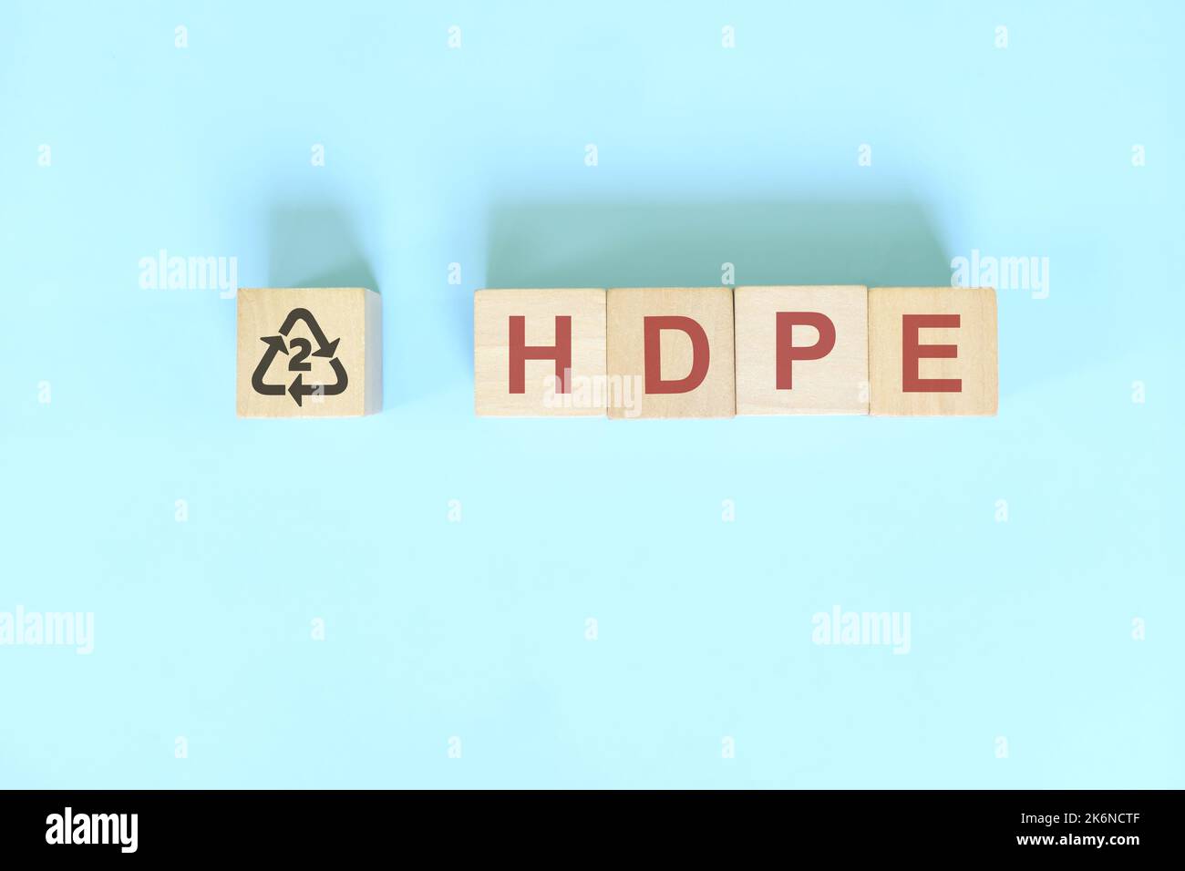 Recycling-Symbol Nummer 2 für HDPE- oder Polyethylen hoher Dichte auf Holzblöcken, flach liegend. Stockfoto