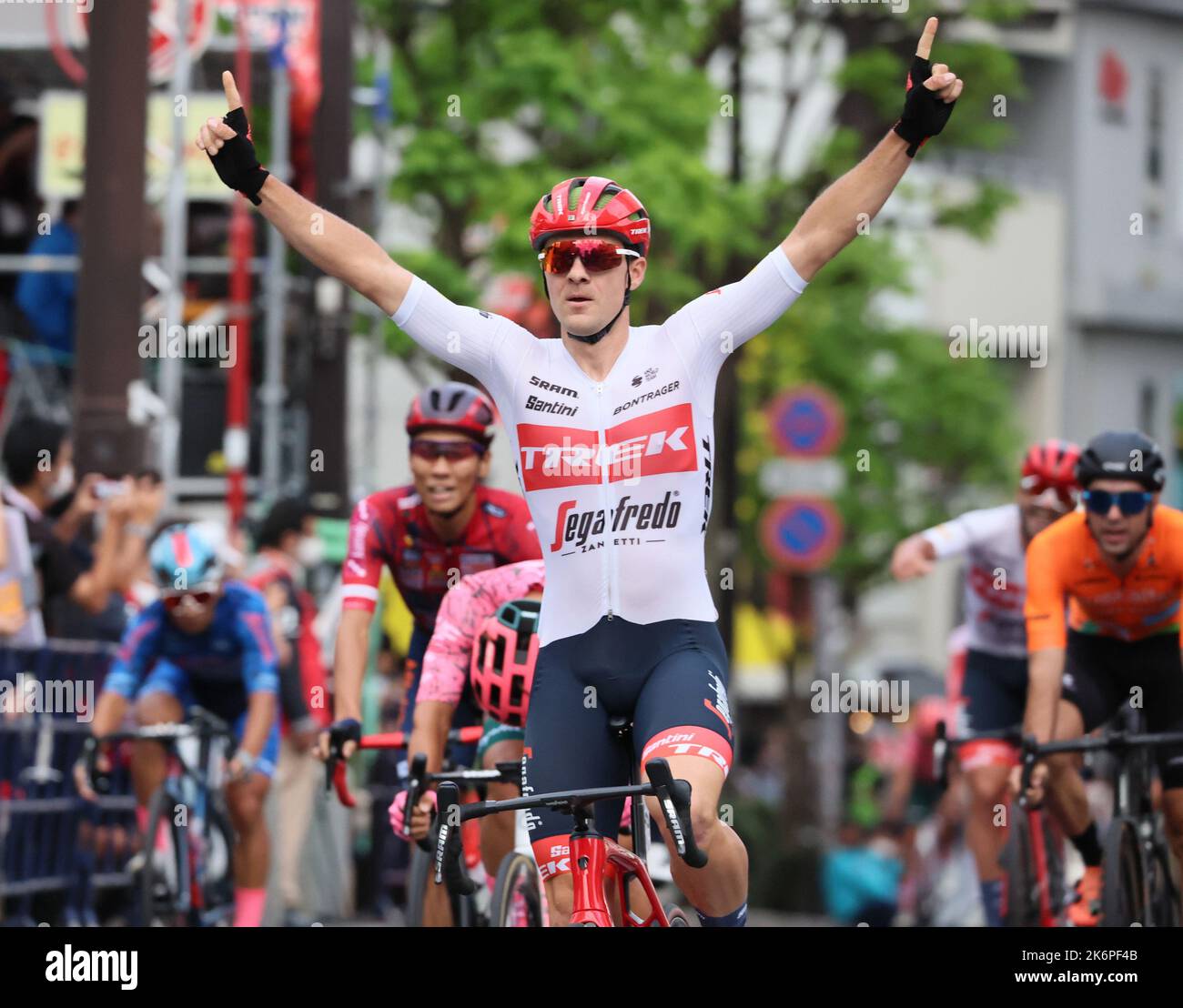 Utsunomiya, Japan. 15. Oktober 2022. Der belgische Radfahrer Edward Theuns von Trek-Segafredo (C) hebt seine Arme in der Luft auf der Ziellinie, als er am Samstag, den 15. Oktober 2022, in Utsunomiya, 100km nördlich von Tokio, das Japan Cup Criterium gewinnt. Theuns gewann das Rennen mit einer Zeit von 41 Minuten und 14 Sekunden. Quelle: Yoshio Tsunoda/AFLO/Alamy Live News Stockfoto