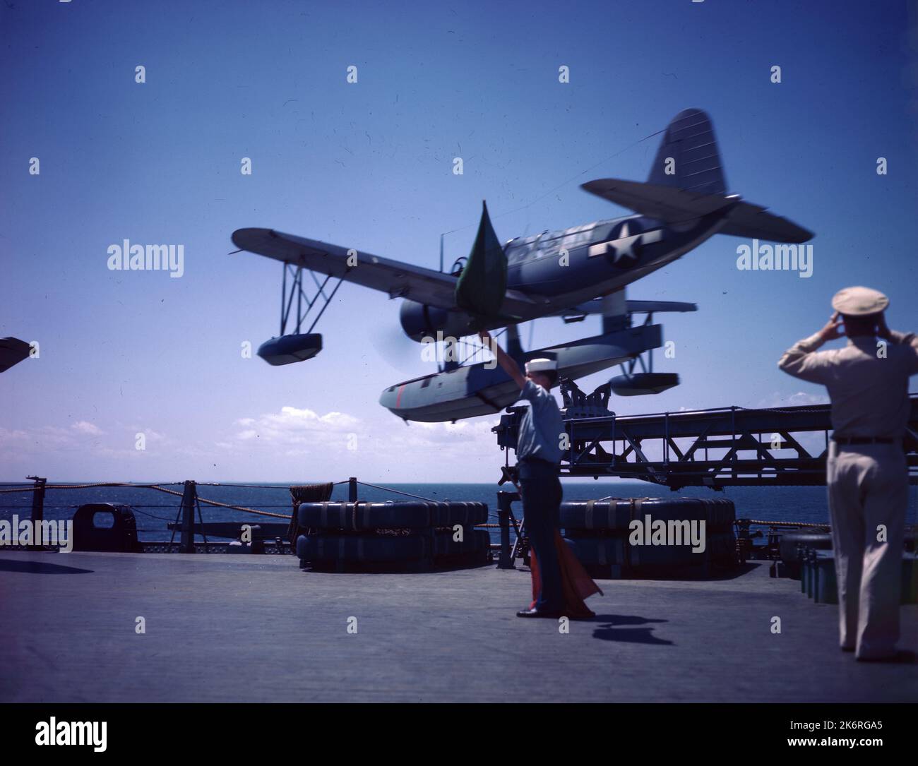 Bildunterschrift auf Negativ Sleeve: „Mit der grünen Flagge startet die Katapult-Crew einen OS2U-Eisvögel von der USS Missouri auf einer Scouting-Mission.“ Stockfoto