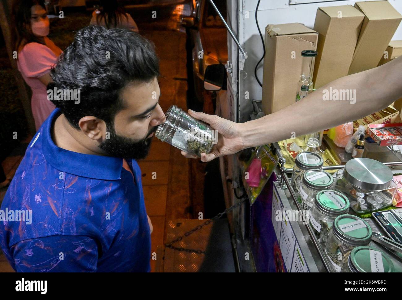 Bangkok, Thailand. 15. Oktober 2022. Ein Kunde riecht nach einem Krug mit Kraut auf Bangkoks Sukhumvit Rd, Soi 11, Marihuana Pop-up-Lastwagen verkaufen legalen Marihuana. Das Königreich Thailand ist die erste Nation in Asien, die Marihuana für den medizinischen und persönlichen Gebrauch entkriminalisiert hat. Am 9. Juni 2022 wurde Marihuana aus der Kategorie der Betäubungsmittel entfernt, wodurch es legal ist, das Kraut zu verkaufen und zu kaufen. Kredit: SOPA Images Limited/Alamy Live Nachrichten Stockfoto