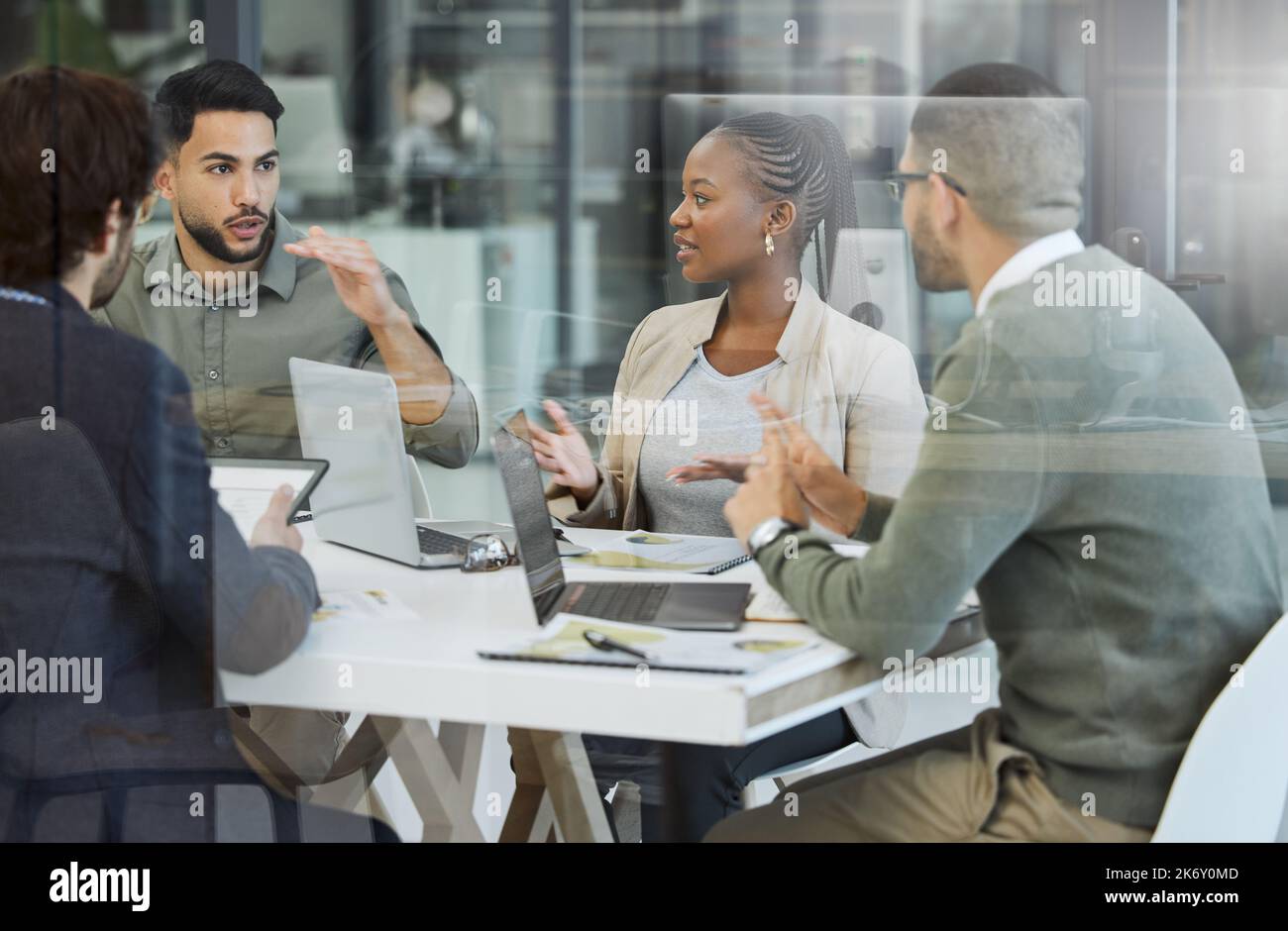 Lassen Sie uns darüber sprechen. Eine Gruppe von Geschäftsleuten, die sich bei der Arbeit in einem Büro treffen. Stockfoto