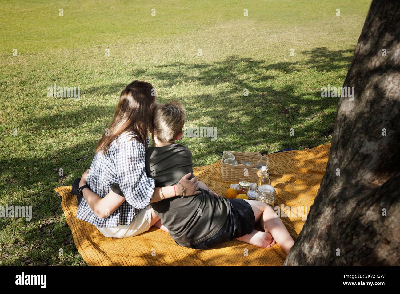 Mutter mit Sohn auf Picknickdecke sitzend Stockfoto