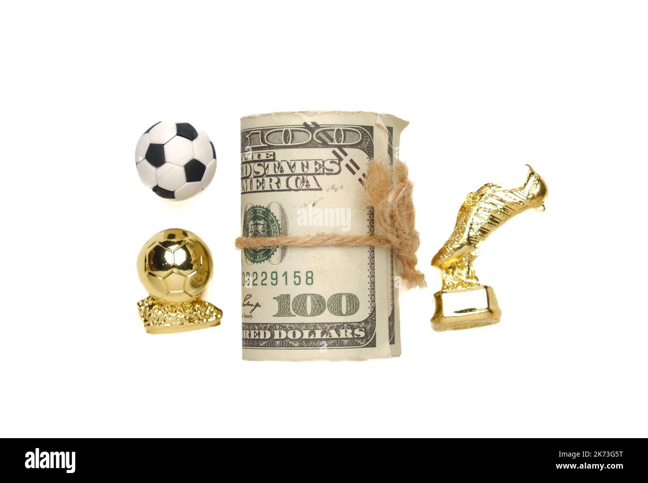 Ein Bild von Fußball, goldenem Stiefel und Ball mit gefälschtem Geld. Fußball Ruhm und Karriere Konzept. Stockfoto