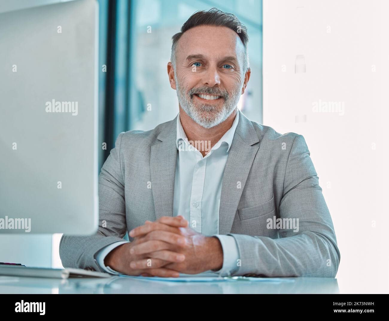 Erfolg ist am besten, wenn er geteilt wird. Ein reifer Geschäftsmann, der bei der Arbeit an einem Schreibtisch sitzt. Stockfoto