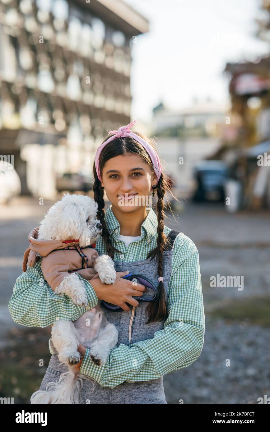 Schöne junge Frau genießen im Freien mit ihrem entzückenden maltesischen Hund. Stockfoto