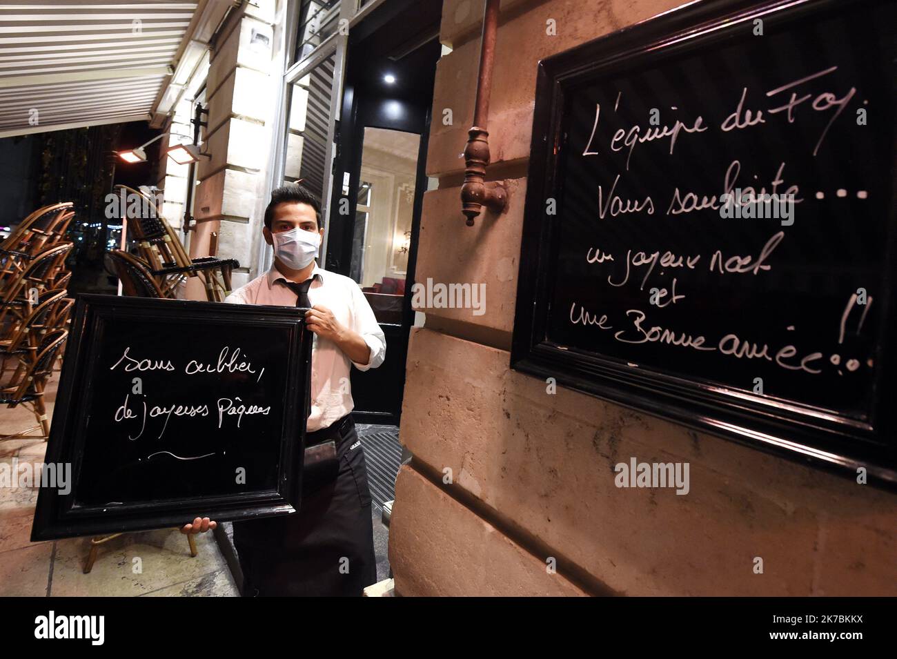 ©PHOTOPQR/L'EST REPUBLICAIN/ALEXANDRE MARCHI ; NANCY ; 29/10/2020 ; SOCIETE - ETWAS D'URGENCE SANITAIRE - SANTE - EPIDEMIOLOGIE DE CORONAVIRUS - PANDEMIE COVID 19 - VERMEHRUNG DU VIRUS - RECONFINEMENT - CONFINEMENT ACTE II - RESTAURATION - RESTAURANT - BAR - FERMETURE - OUVERTURE - REOUVERTURE. Nancy 29 Oktober 2020. UN serveur du Grand Café Foy, sur la Place Stanislas, porte un panneau avec l'inscription 'sans oublier de joyeuses Pâques' à l'heure du couvre-feu (21 heures) qui se prolongera par un confinement national jusqu'au 1er décembre à minima dans le cadre de l'état d'urgence sanitaire face Stockfoto