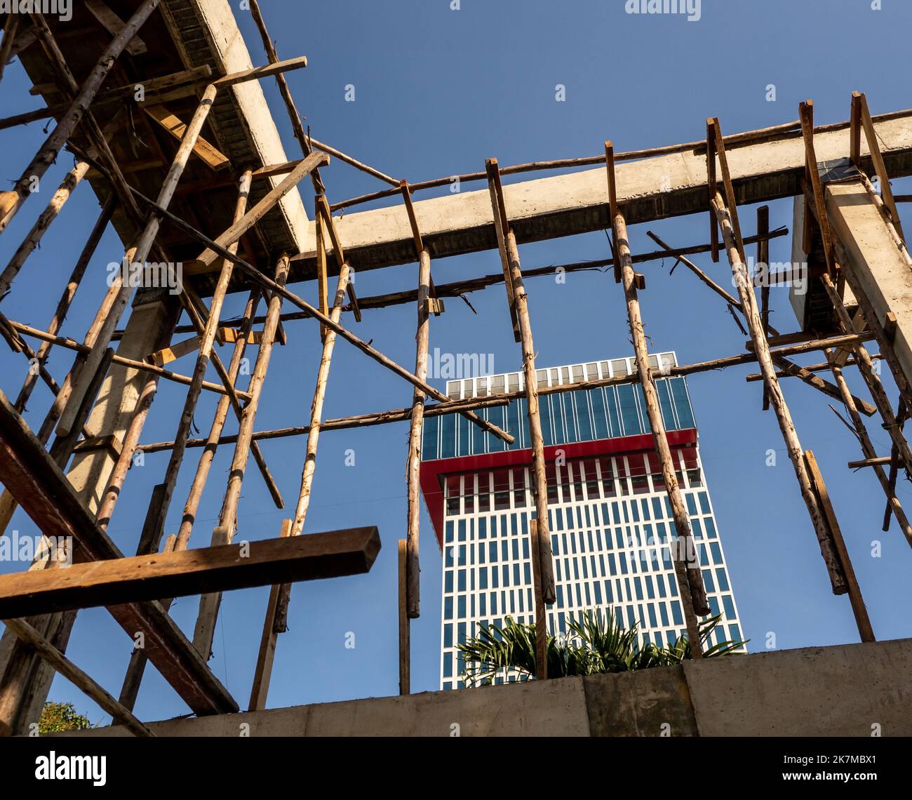 Provisorischer Holzmast für Stützen der Betonkonstruktion eines im Bau befindlichen Gebäudes Stockfoto