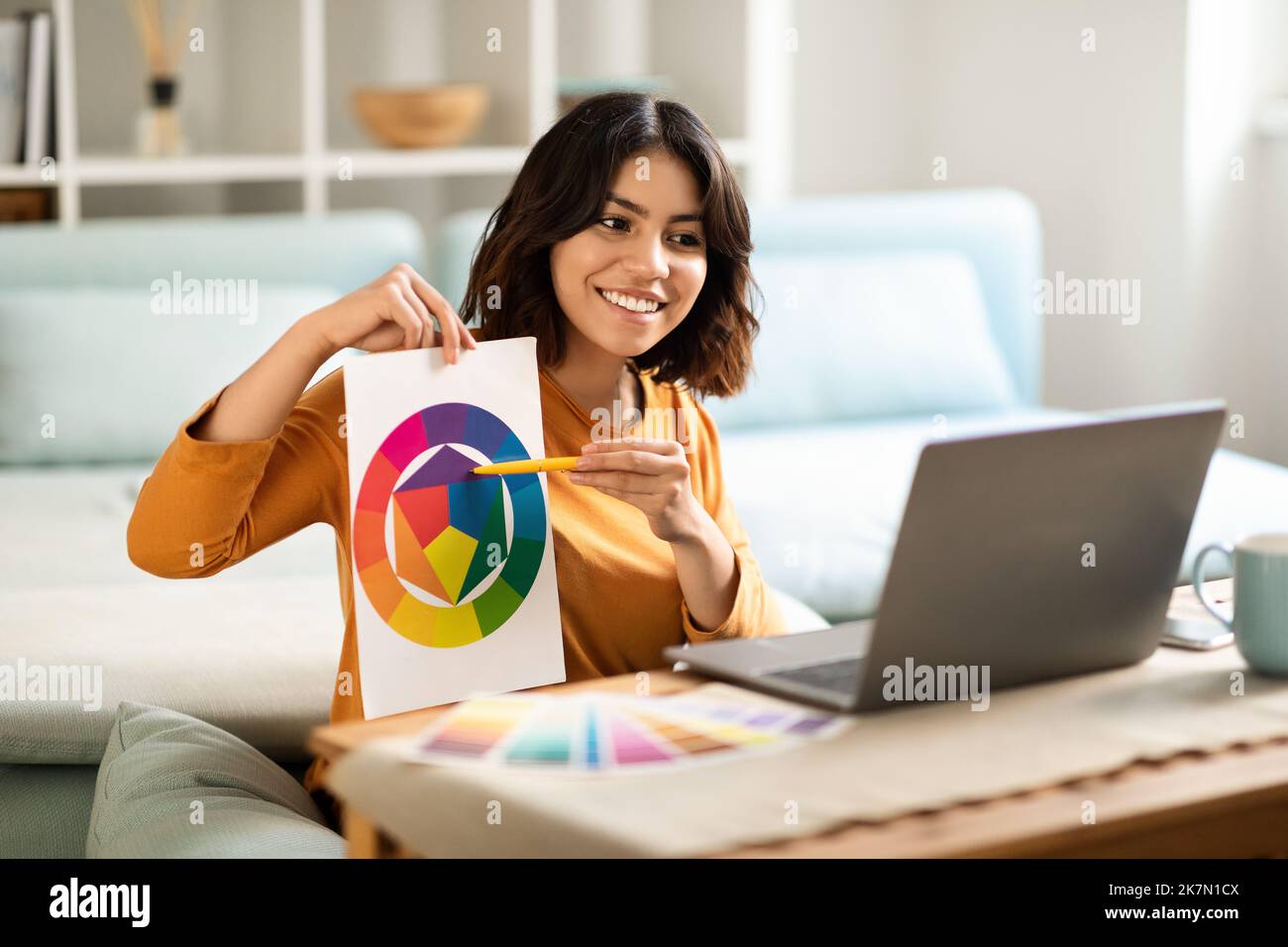 Tutoring-Konzept. Arabische Grafikdesignerin Zeigt Farbfelder An Der Laptop-Kamera Stockfoto