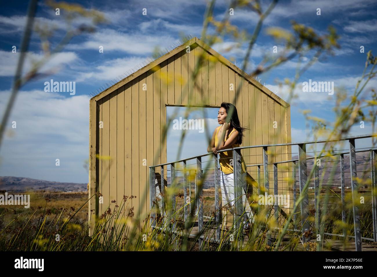 Porträt einer jungen Frau, die vor einem Torweg zum Baylands Nature Preserve steht Stockfoto