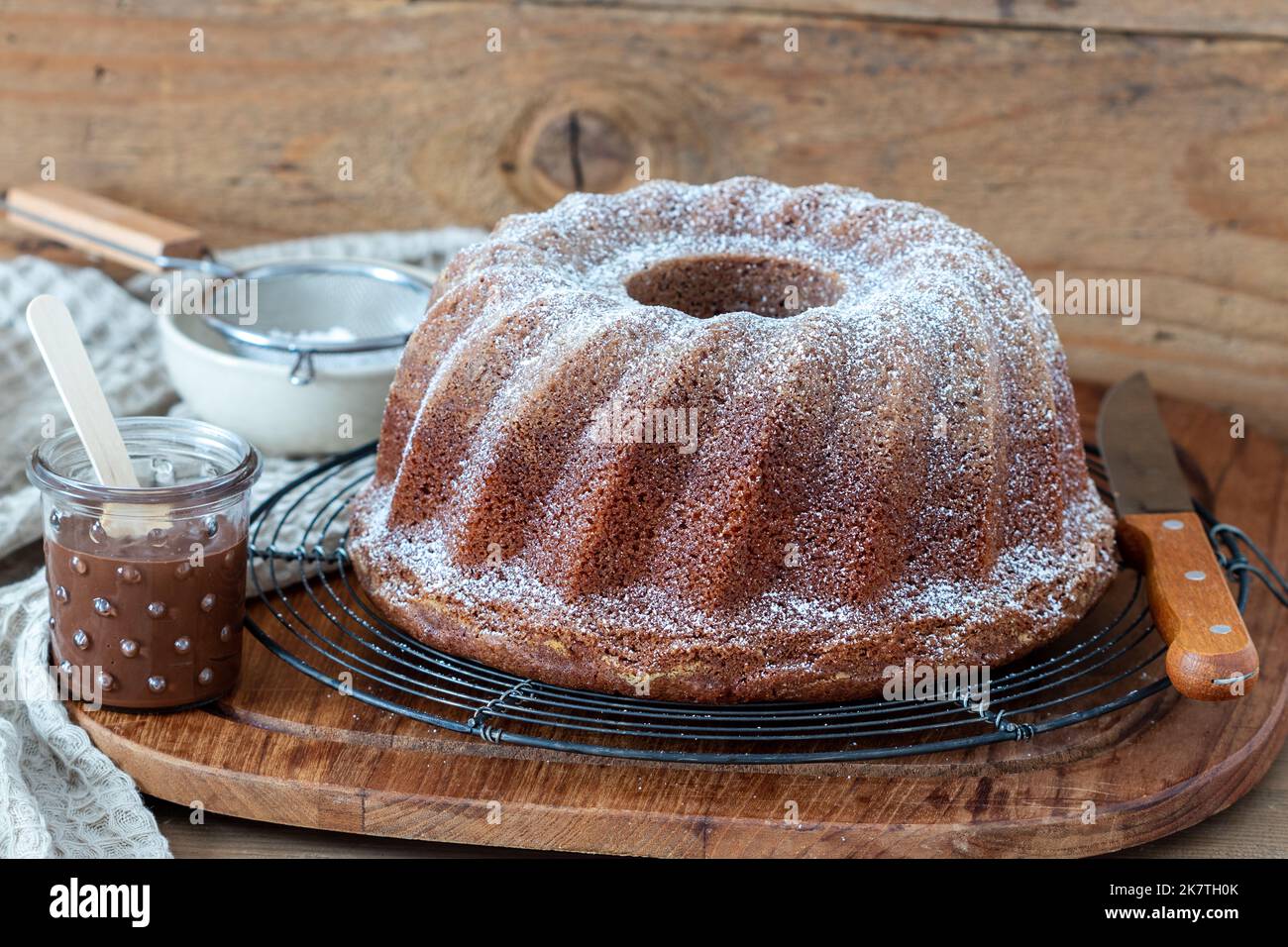 guglhupf mit Nuss-Nougat-Creme auf dem Kuchenständer Stockfoto