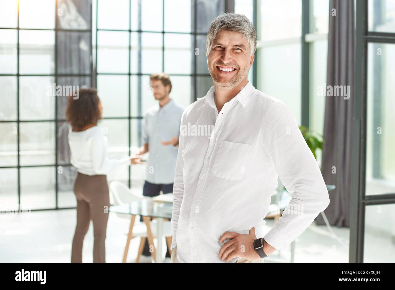 Selbstbewusster Geschäftsmann, der im Büro steht. Stockfoto