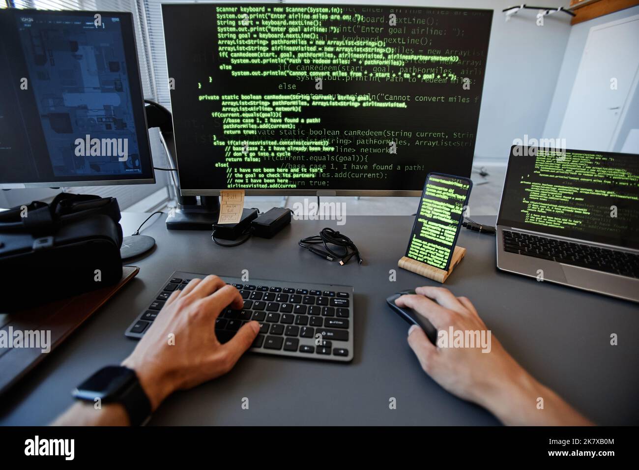 POV Schuss von Computer-Programmierer arbeiten mit grünen Code-Linien auf mehreren Geräte-Bildschirme, Copy Space Stockfoto
