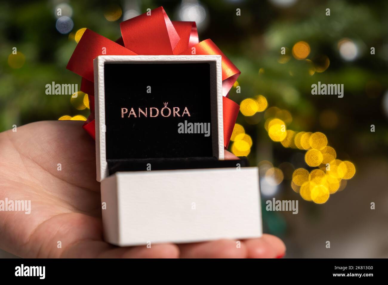 Pandora-Box mit einer roten Schleife in der Womans Hand gegen den  Weihnachtsbaum. Geschenk für ein glückliches neues Jahr und  Weihnachtsfeier. Oktober 2022, Prag, Tschechische Republik Stockfotografie  - Alamy