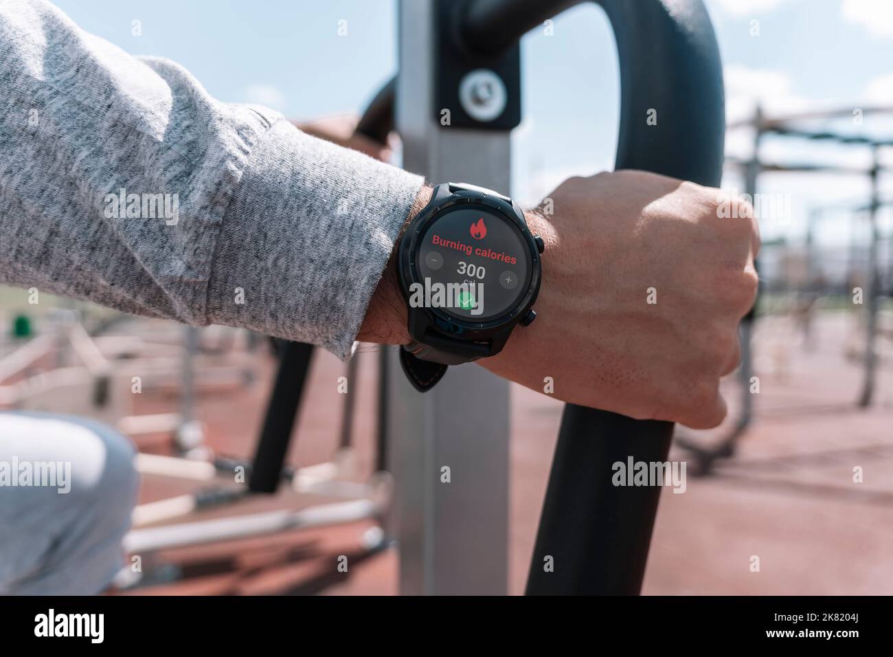 Ein Mann im Stadion. Kalorien verbrannten in seiner Smartwatch. Tägliche Bewegung an der frischen Luft für die Gewichtsabnahme. Intelligente Gadgets für den Sport. Armbanduhr Stockfoto