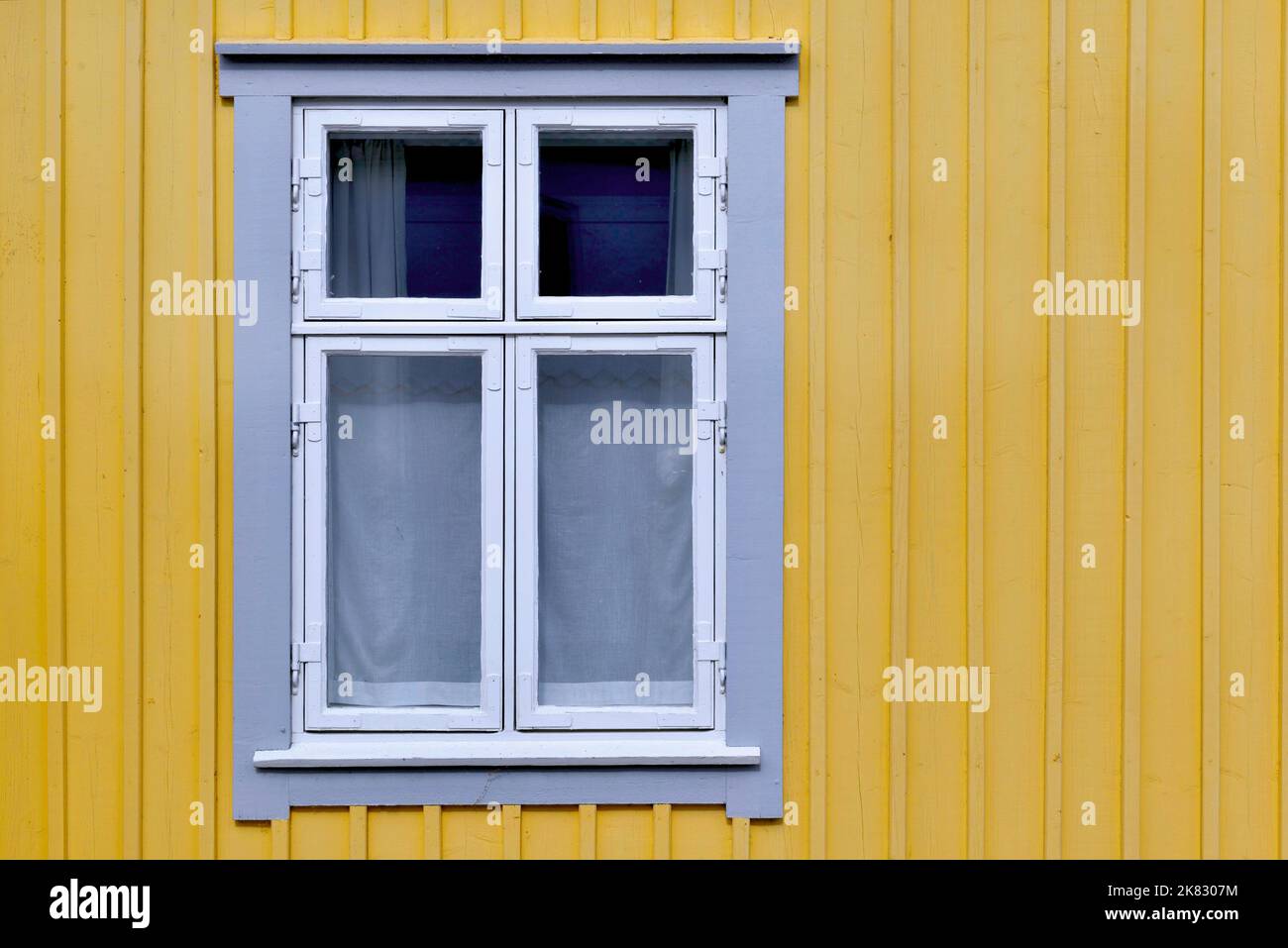 Nahaufnahme des Fensters an der Fassade eines in Gelb gestrichenen schwedischen Hauses Stockfoto