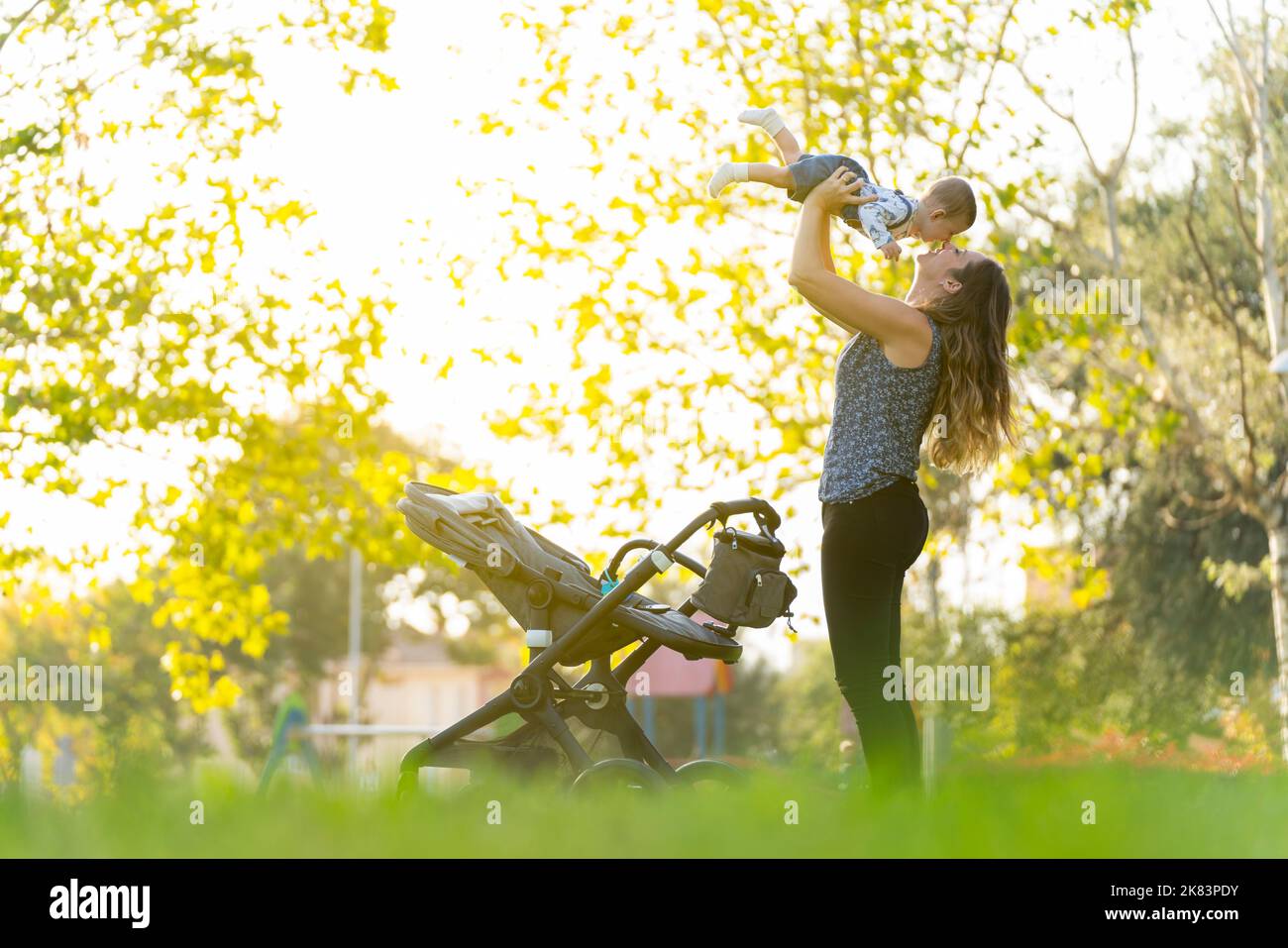 Mutter mit ihrem Sohn, der im Park spielt und lacht Stockfoto