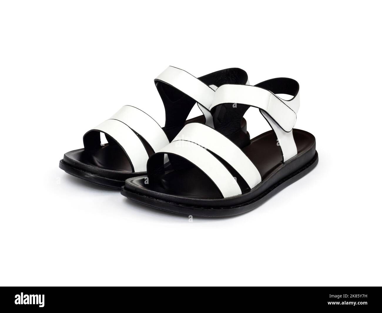 Paar schwarze und weiße weibliche Sandalen isoliert auf weißem Hintergrund mit Clipping-Pfad Stockfoto