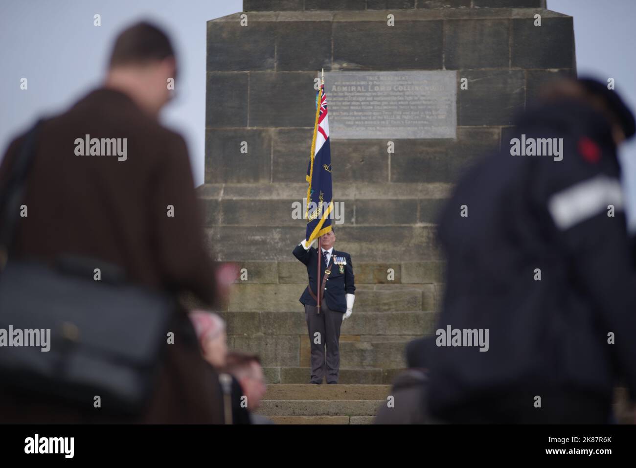 Tynemouth, Großbritannien. 21. Oktober 2022. Ein Fahnenträger der Royal British Legion steht auf dem Collingwood's Monument während des jährlichen Anstoßereignisses auf das Admiral Event. Quelle: Colin Edwards/Alamy Live News. Stockfoto