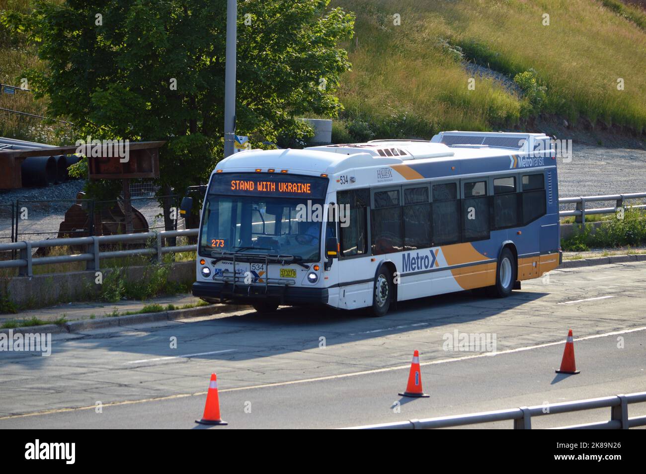 Halifax Transit Nova Bus LFS, in alter Metro Transit 'MetroX' Lackierung, geparkt an der Upper Water Street in der Innenstadt von Halifax mit 'Stand with Ukraine' Schild Stockfoto