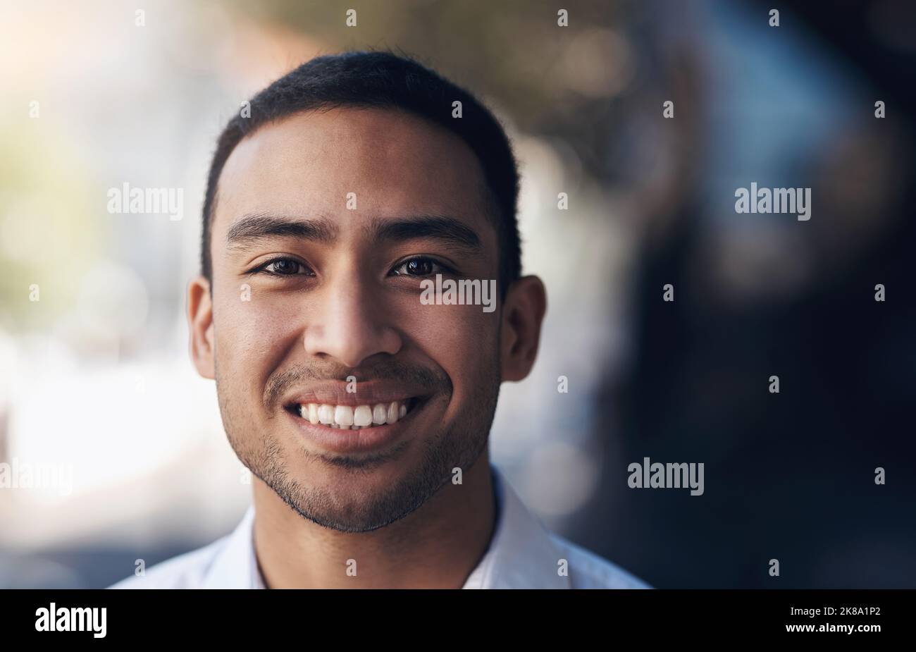 Ich bin stolz auf meine Leistungen. Ein hübscher junger Geschäftsmann, der tagsüber alleine auf seinem Bürobalkon steht. Stockfoto